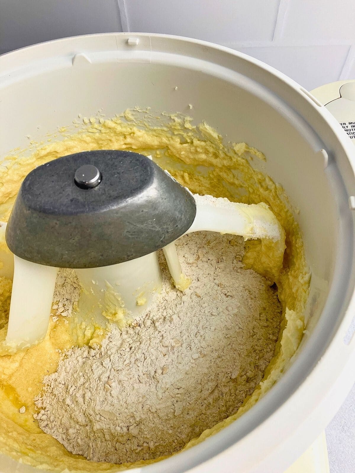 The dry ingredients are added to the mixer bowl with the wet ingredients.