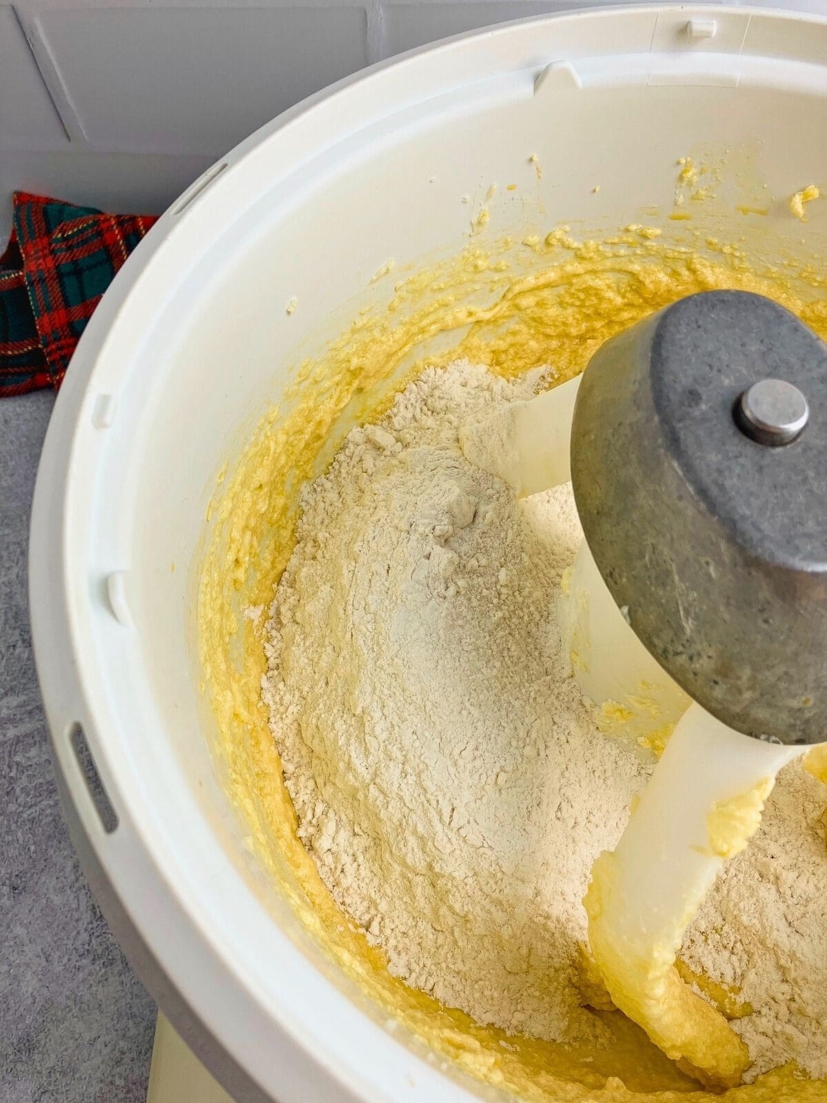 Dry ingredients are added to the mixer bowl.