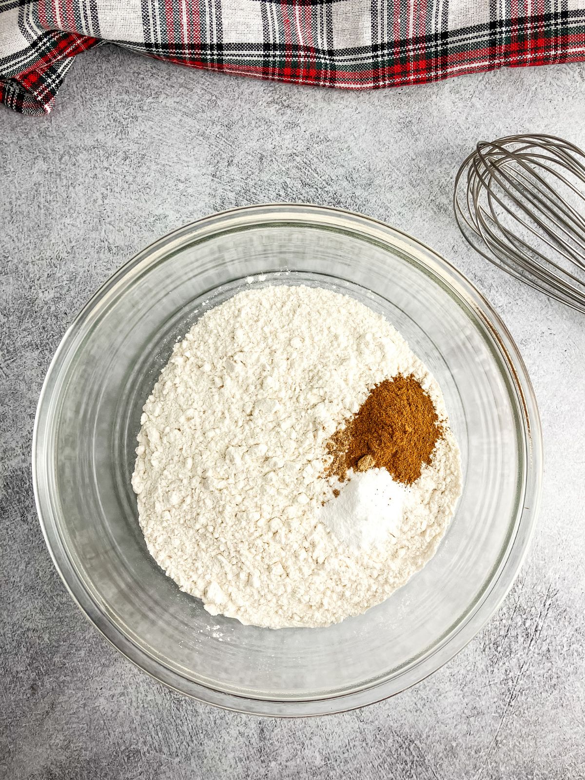 Dry ingredients for the cookies in a glass mixing bowl.