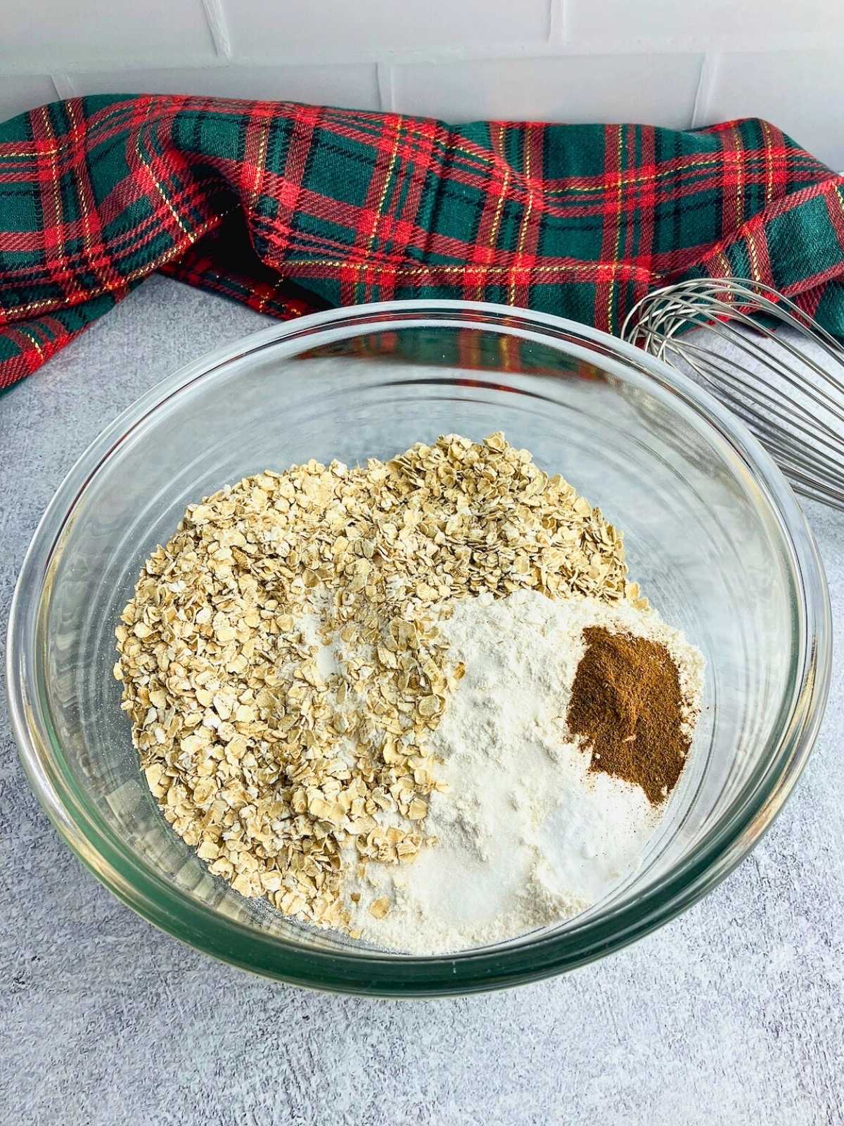 The dry cookie ingredients are in a glass mixing bowl.