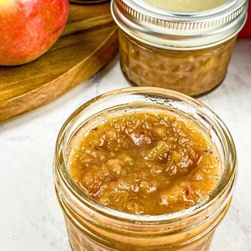 Easy Instant Pot apple chutney recipe poured into small mason jars.
