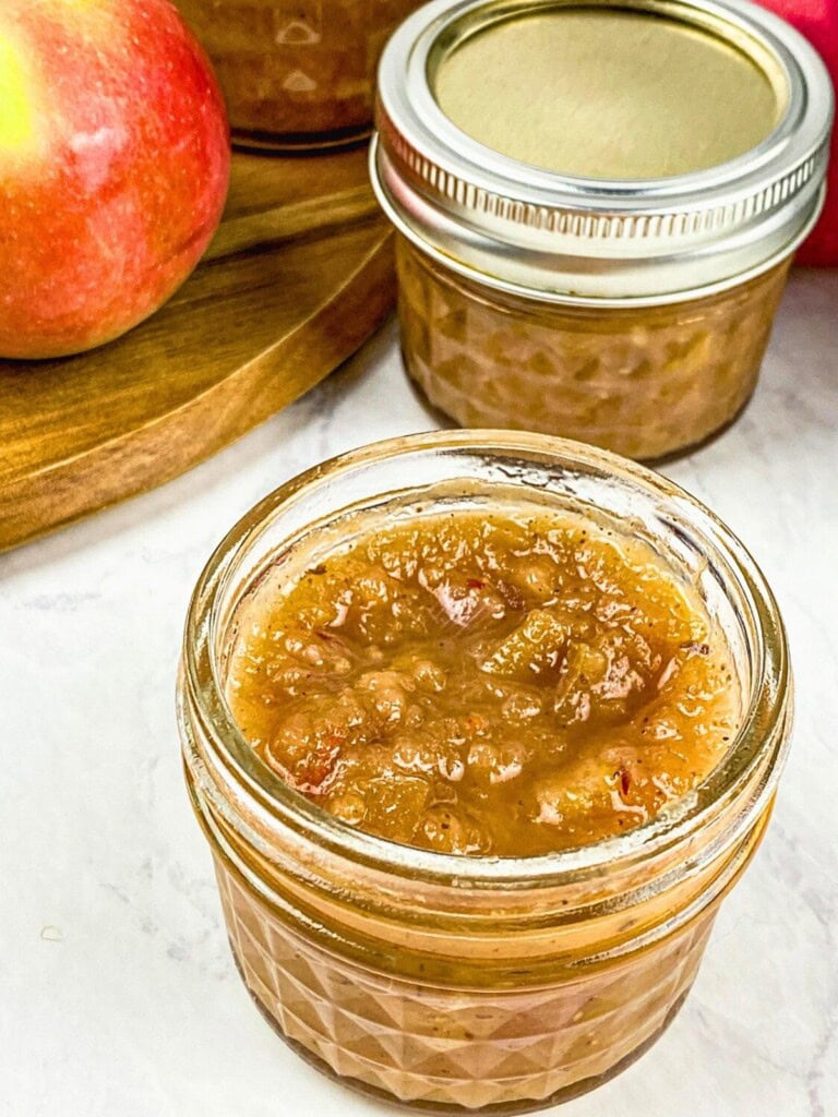 Easy Instant Pot apple chutney recipe poured into small mason jars.