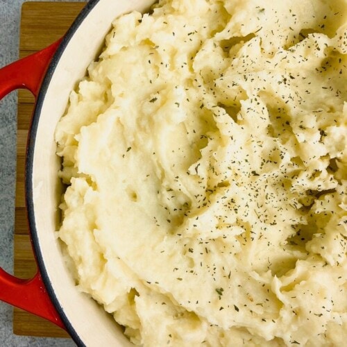 Homemade mashed potatoes in a red cast iron pot.