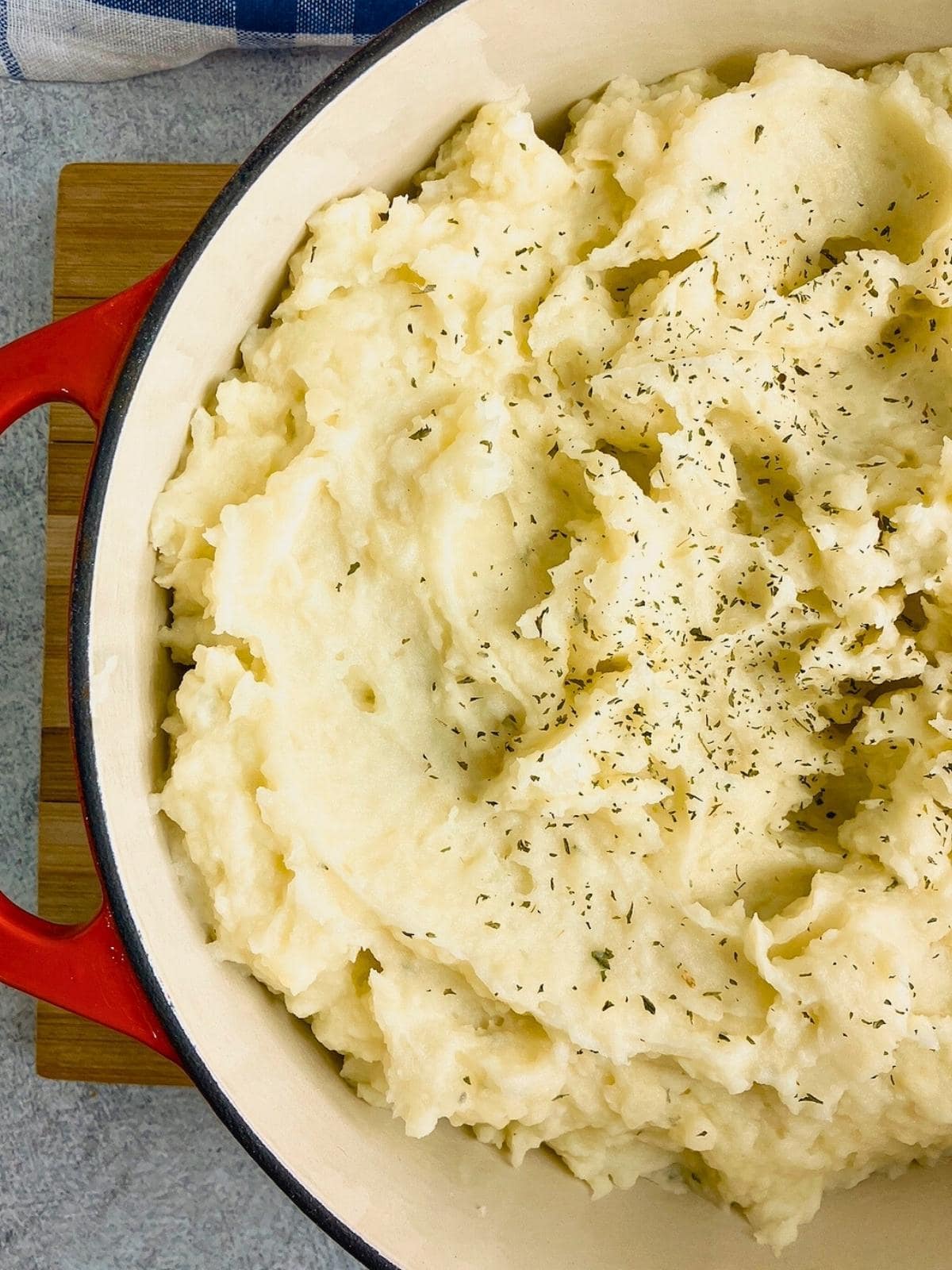 Homemade mashed potatoes in a red cast iron pot.