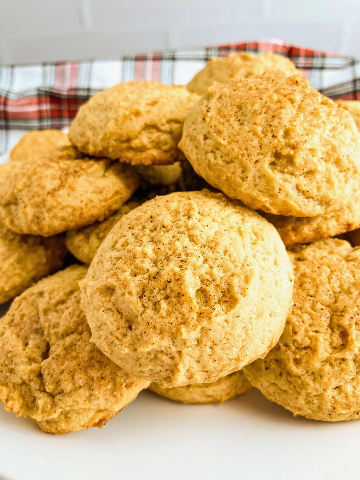 Homemade eggnog cookies on a white platter.