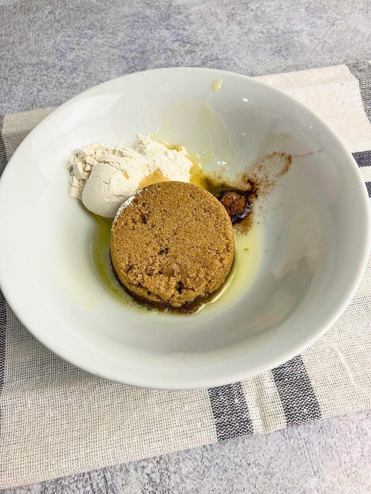 Brown sugar, flour, cinnamon, and melted butter in a small bowl.