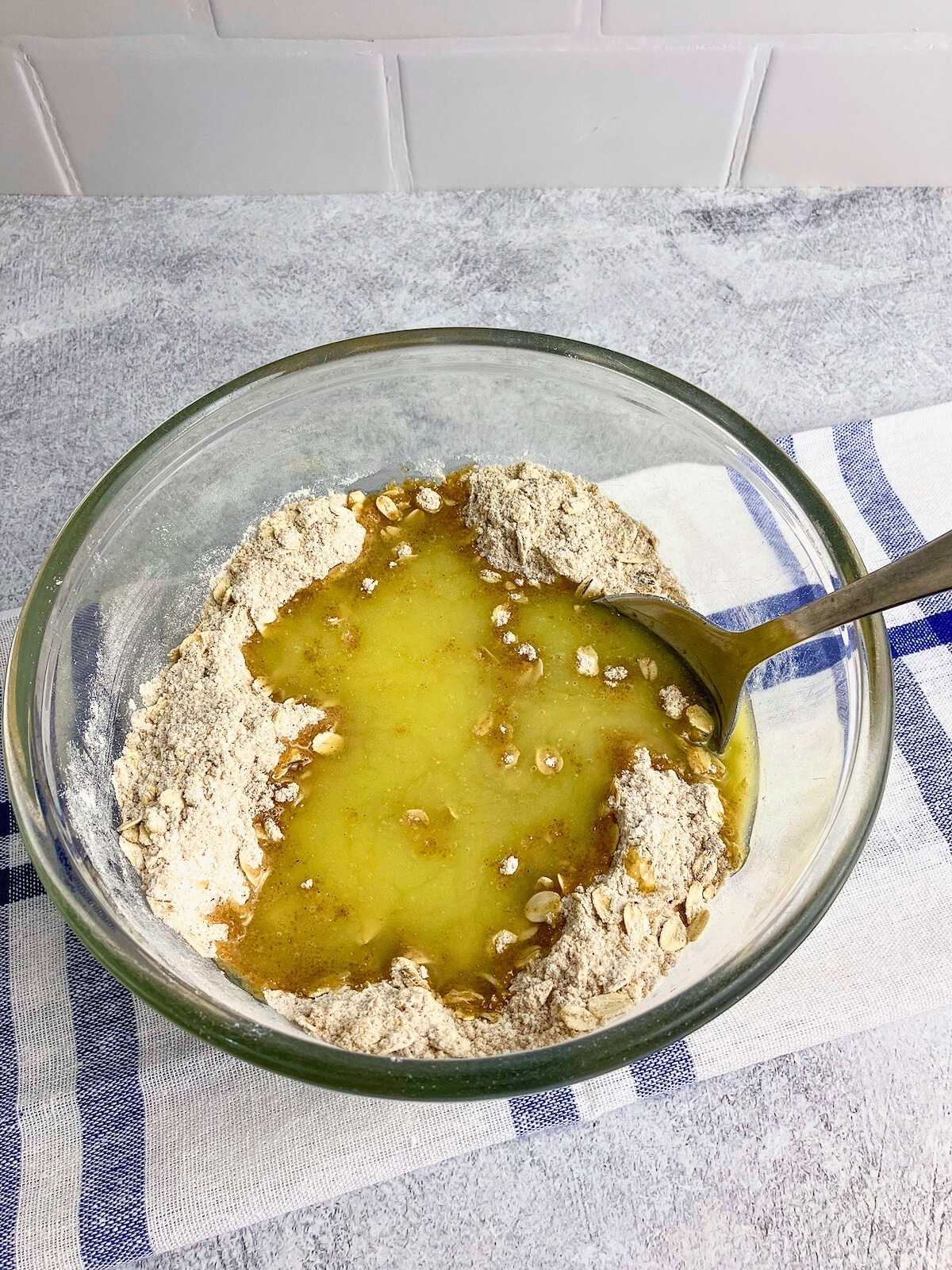Melted butter is added to the dry topping ingredients.