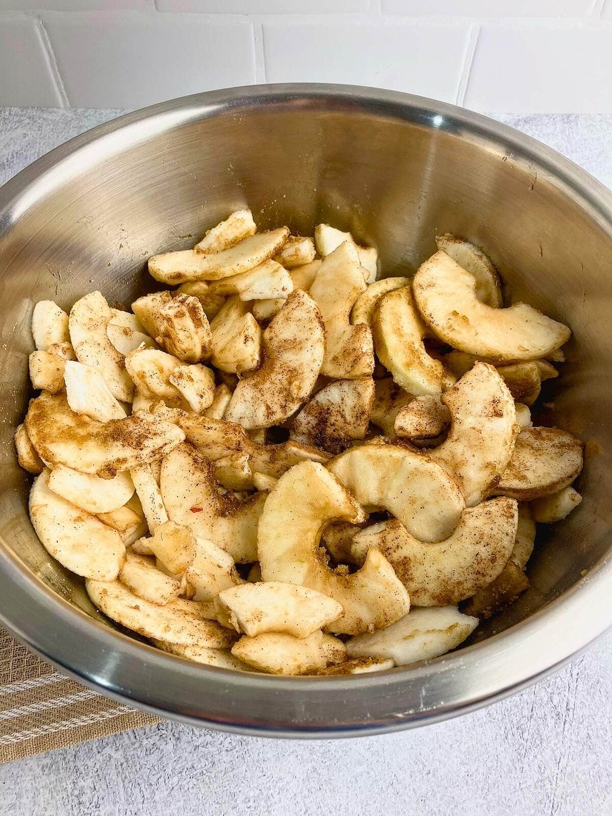 Sliced apples mixed with the spices and sugar.