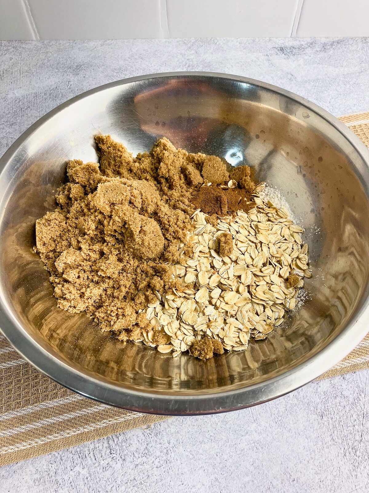 Oats, flour, brown sugar, and spices in a large mixing bowl.