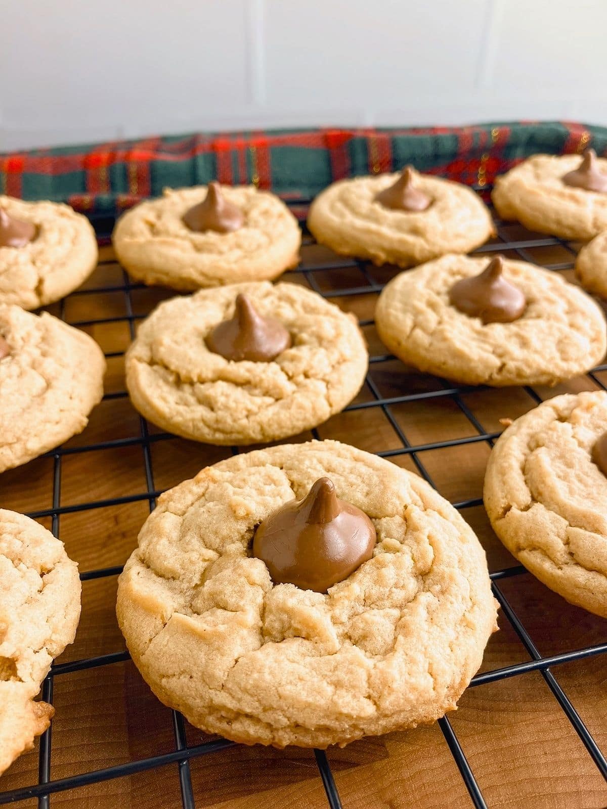 Warm peanut butter blossoms on a cooling rack.