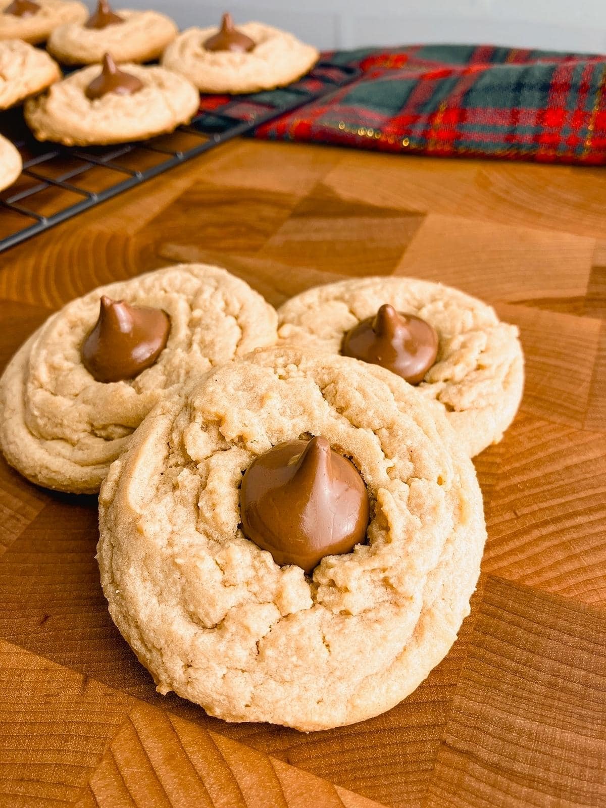 Homemade peanut butter blossoms on a wooden table.