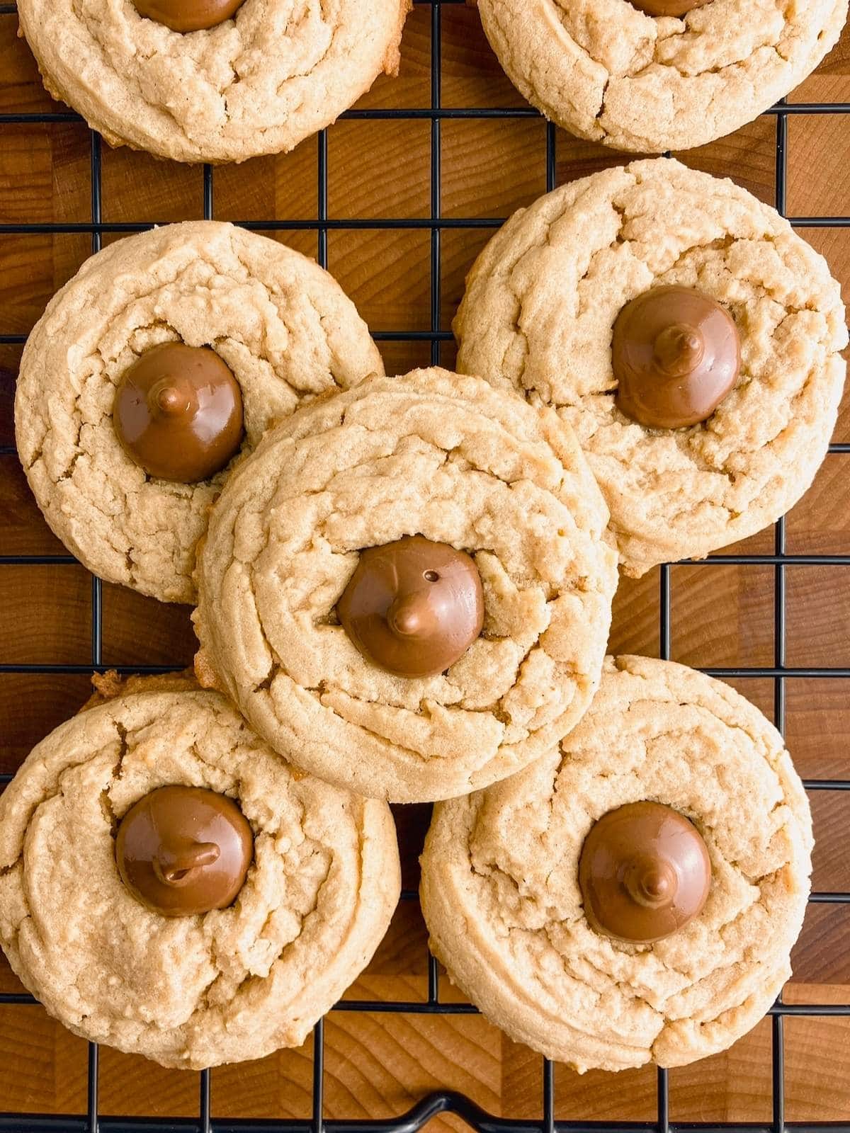 Peanut butter blossom cookies on a wire cooling rack.