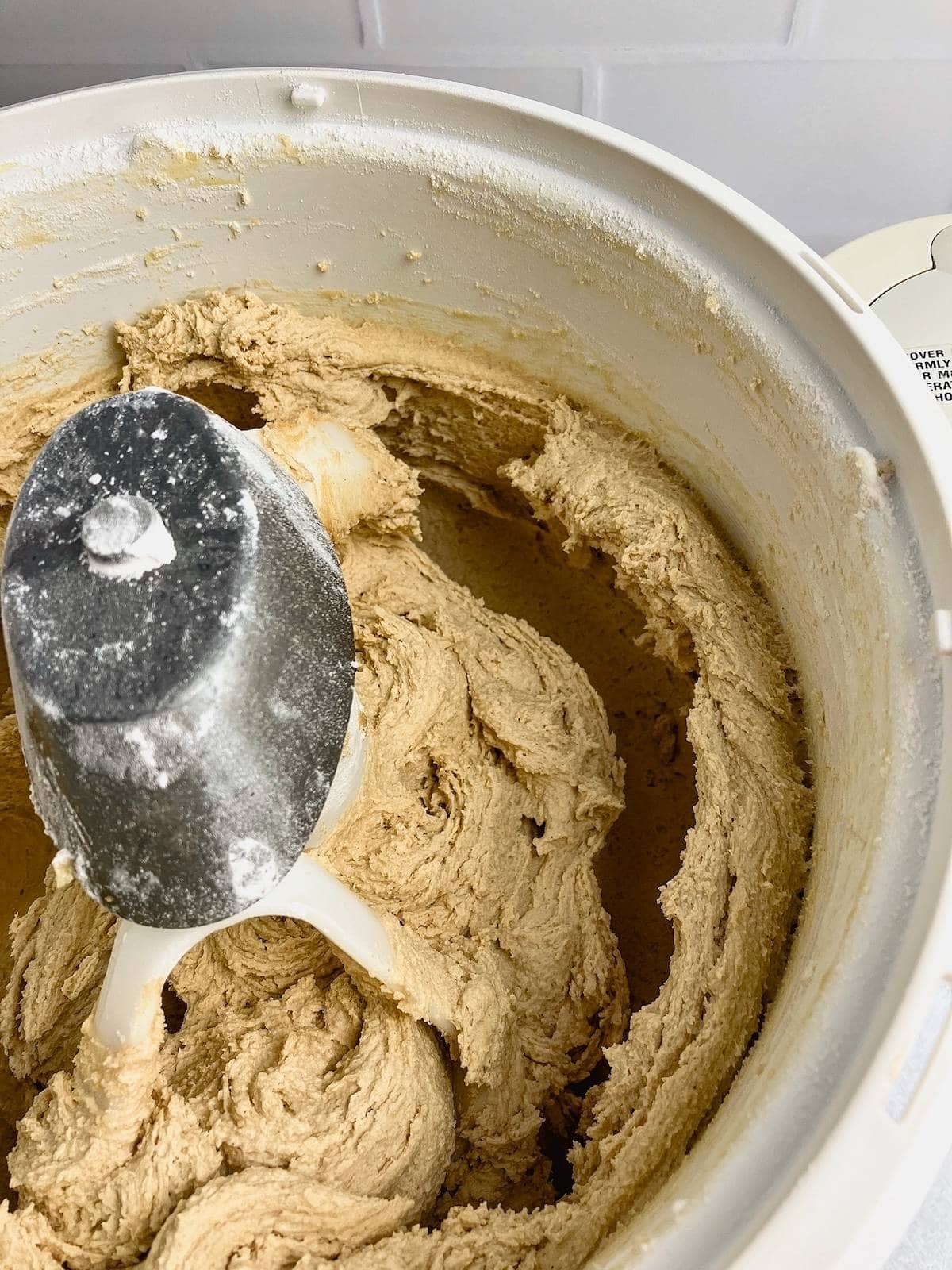 Peanut butter blossom cookie dough in the stand mixer.