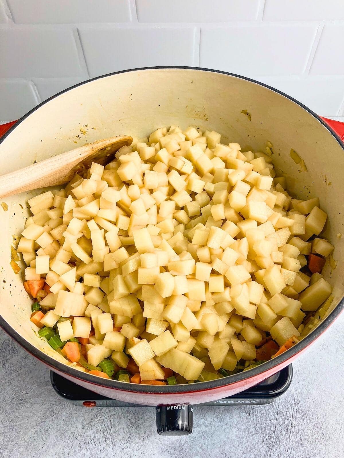 Diced potatoes were added to the sauteed vegetables.