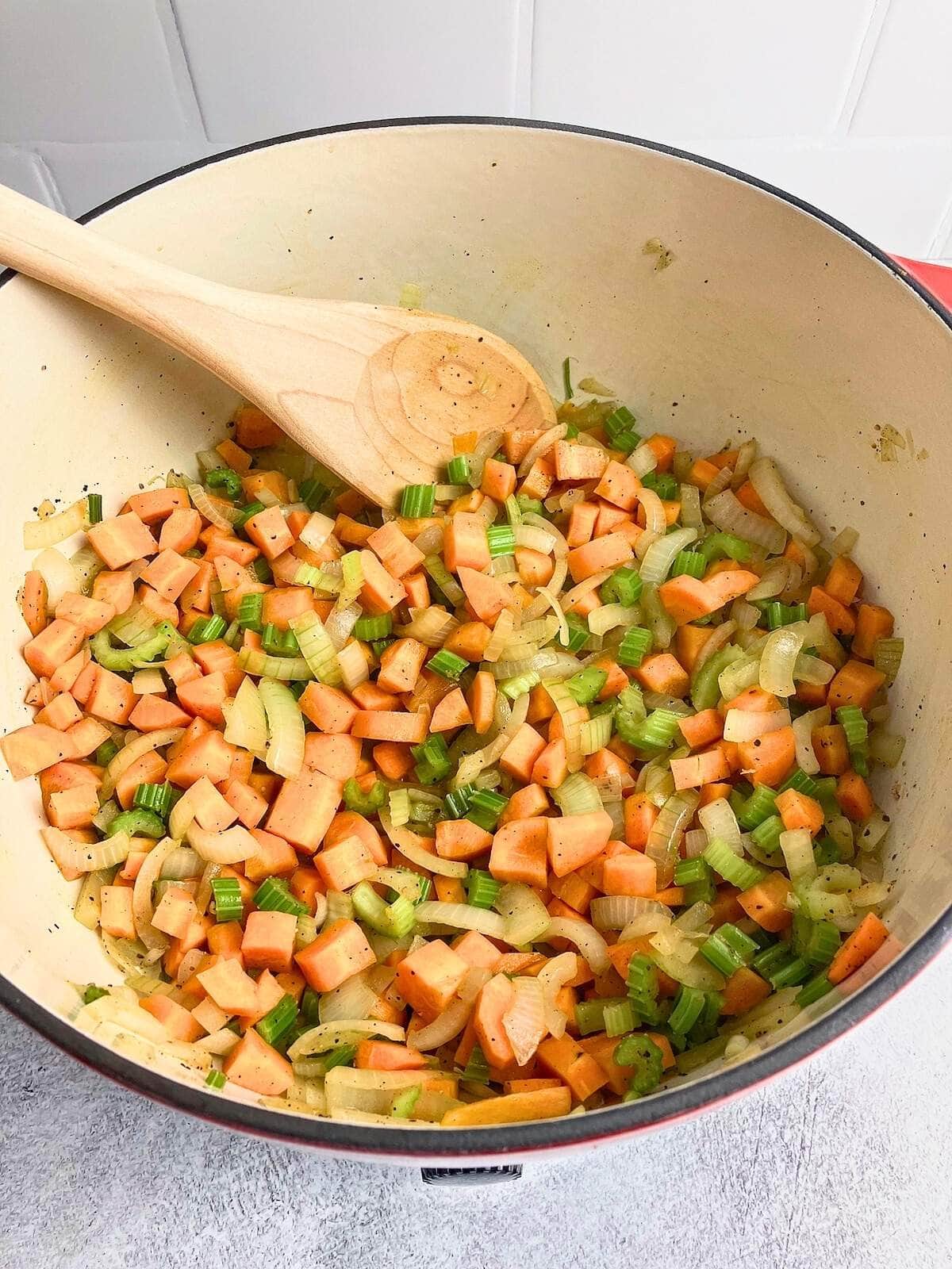 The sauteed vegetables in the Dutch oven were finished cooking.