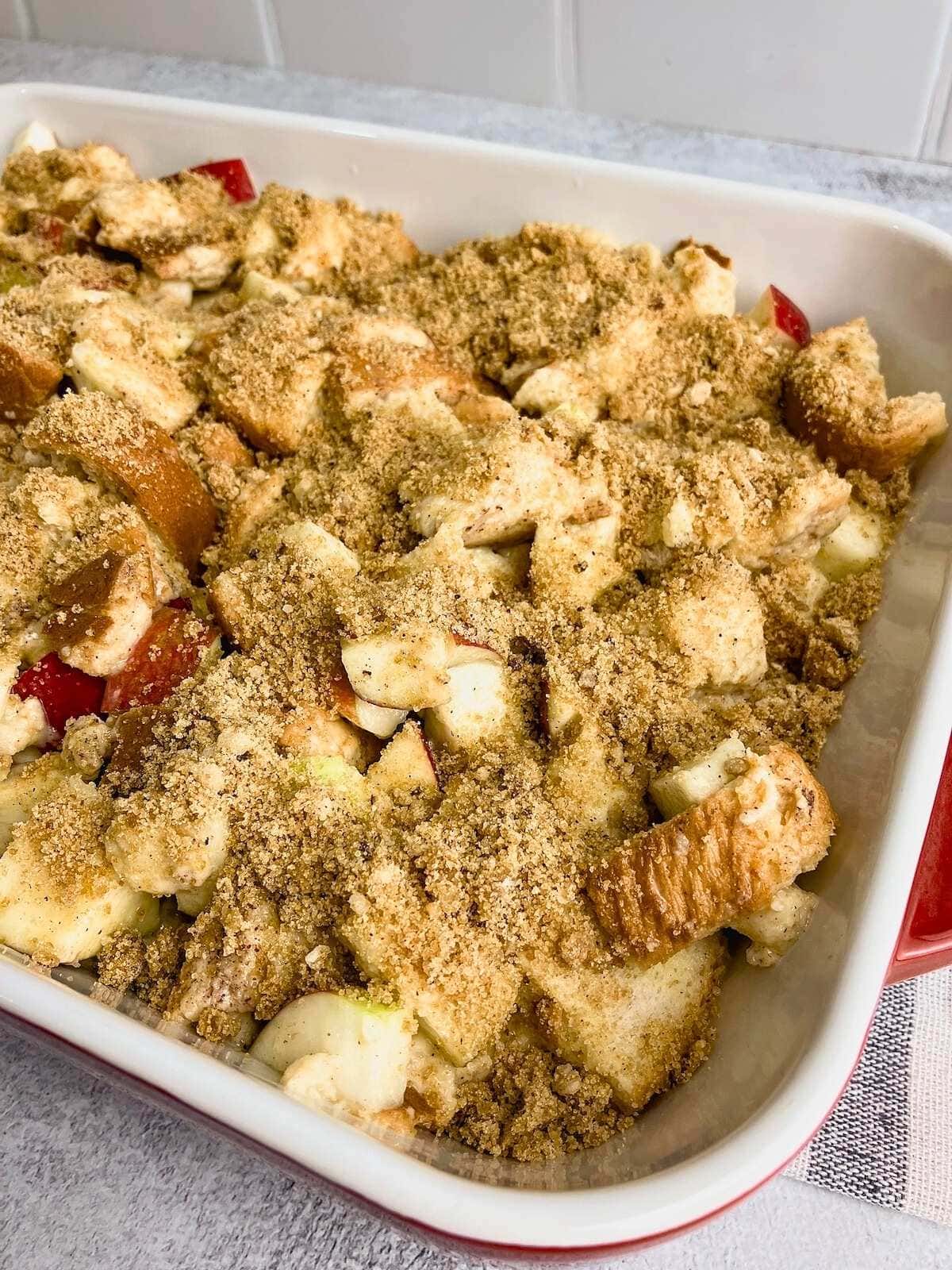 Brown sugar and cinnamon topping are spread over the top of the casserole.