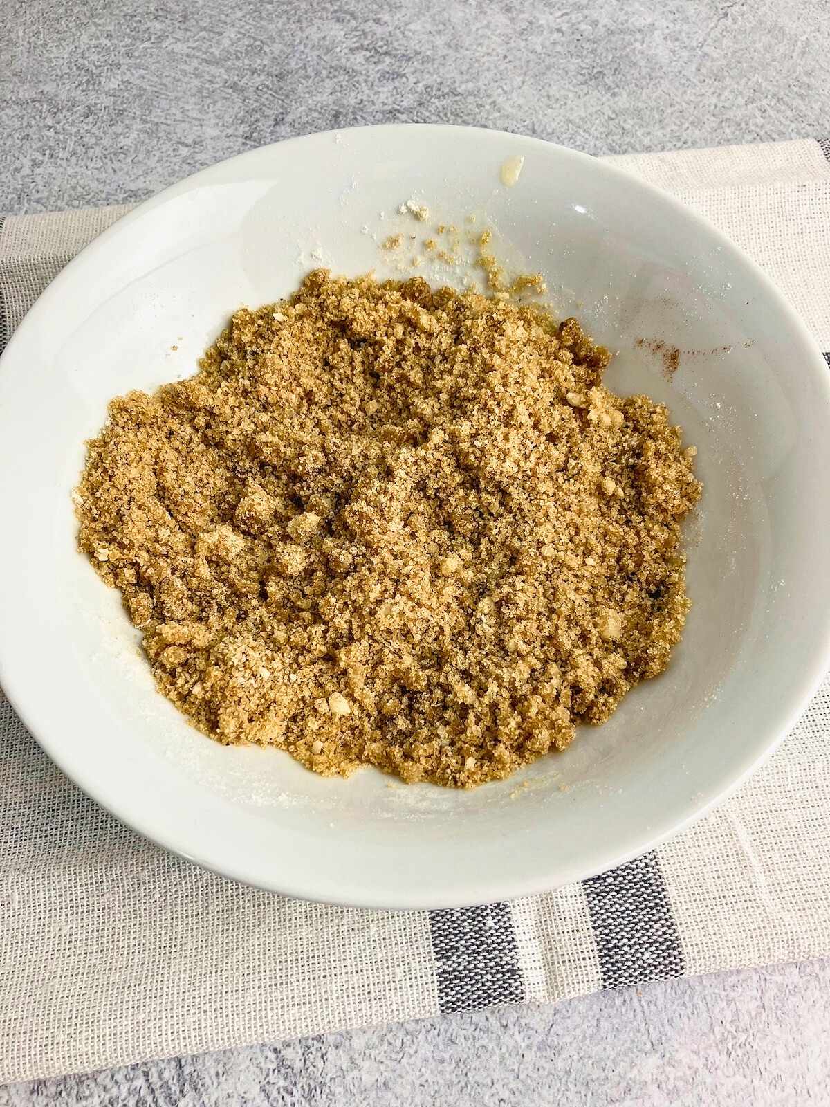 Brown sugar topping in a white bowl.