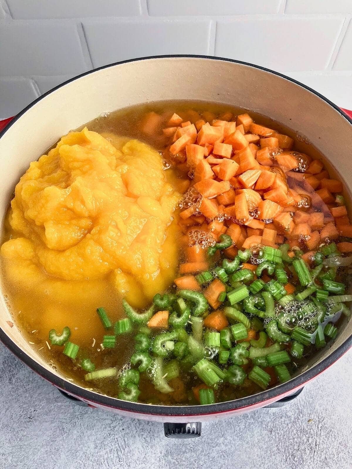 Chicken broth was added to the pot of meat and vegetables.