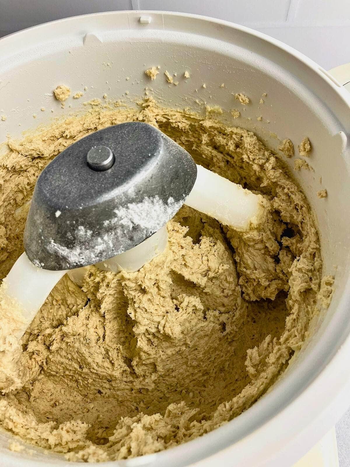 Cookie batter is mixed together in the stand mixer.