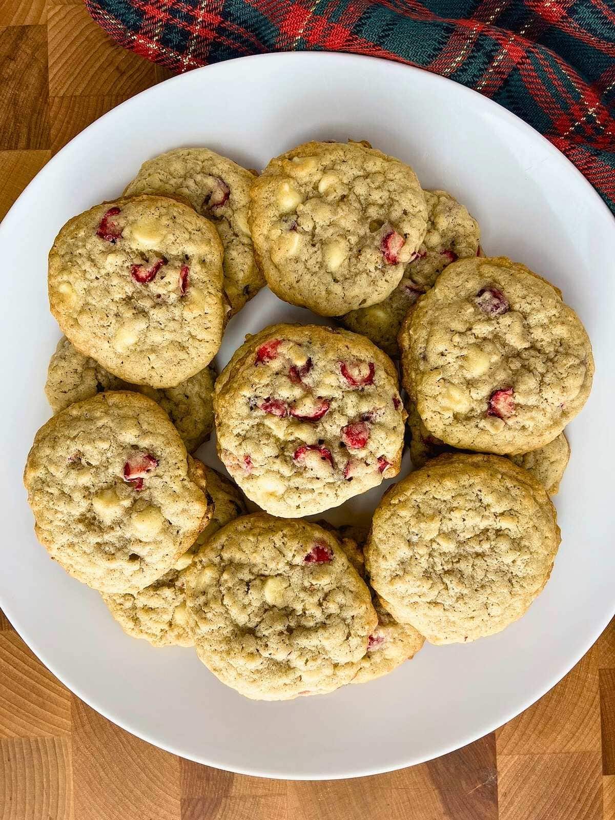 A white platter of cranberry chocolate chip oatmeal cookies.