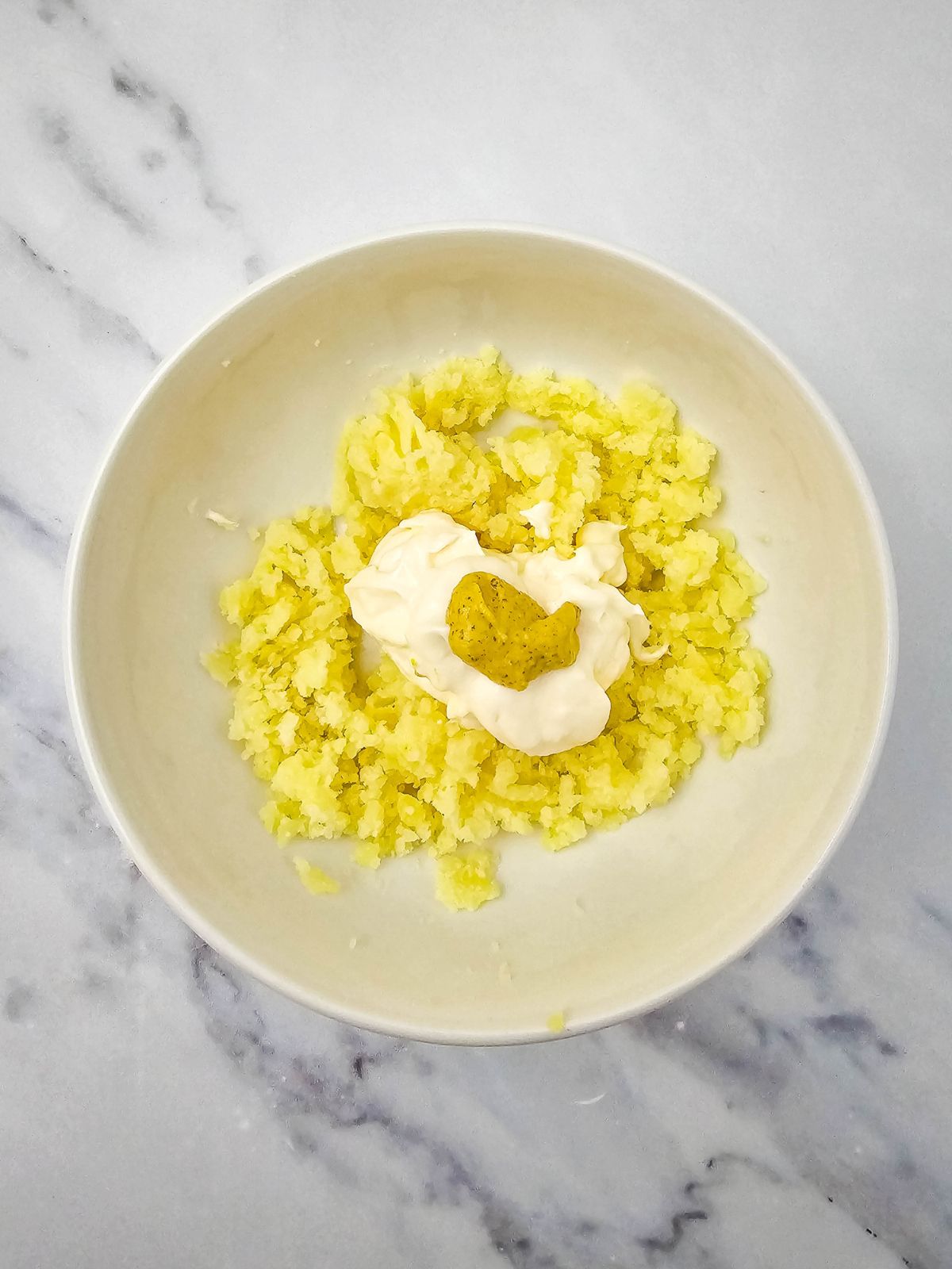 Dijon mustard is added to the potato mixture.