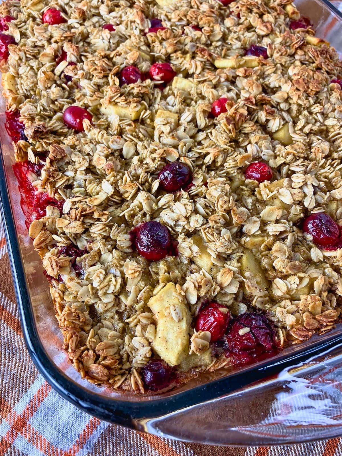 Warm cranberry apple baked oatmeal is cooling on the counter.