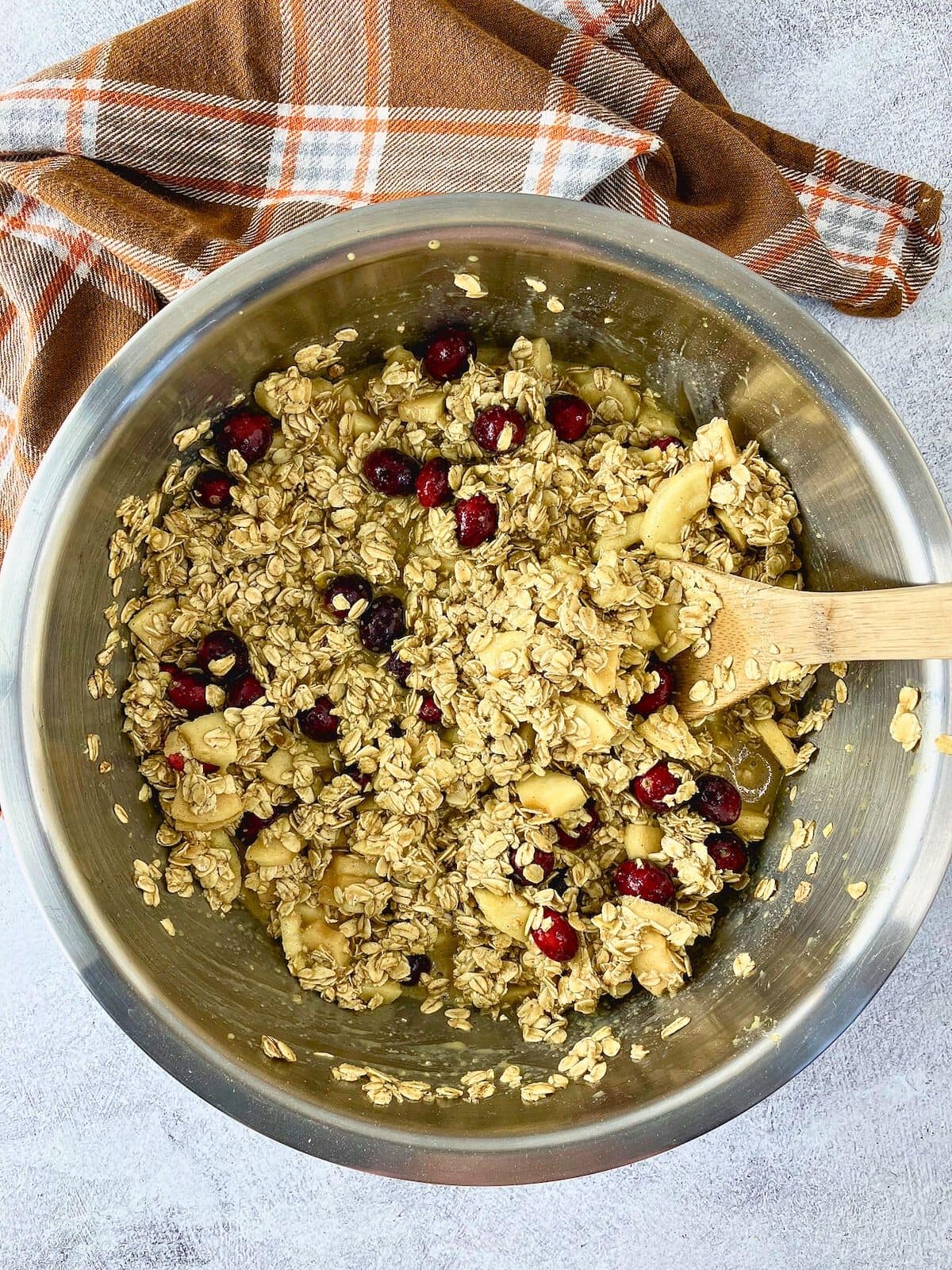 The apples and cranberries have been folded into the oatmeal batter.