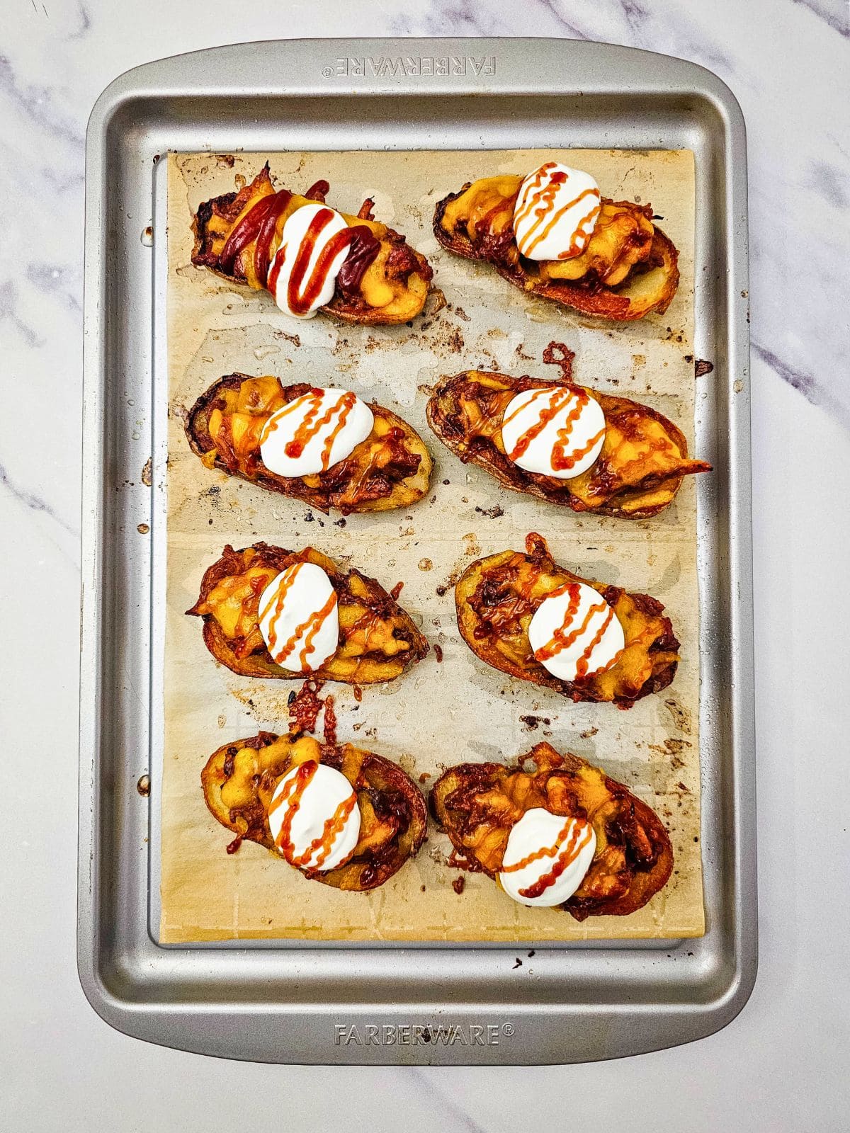 BBQ sauce was drizzled over the top of the sour cream and potato skins.