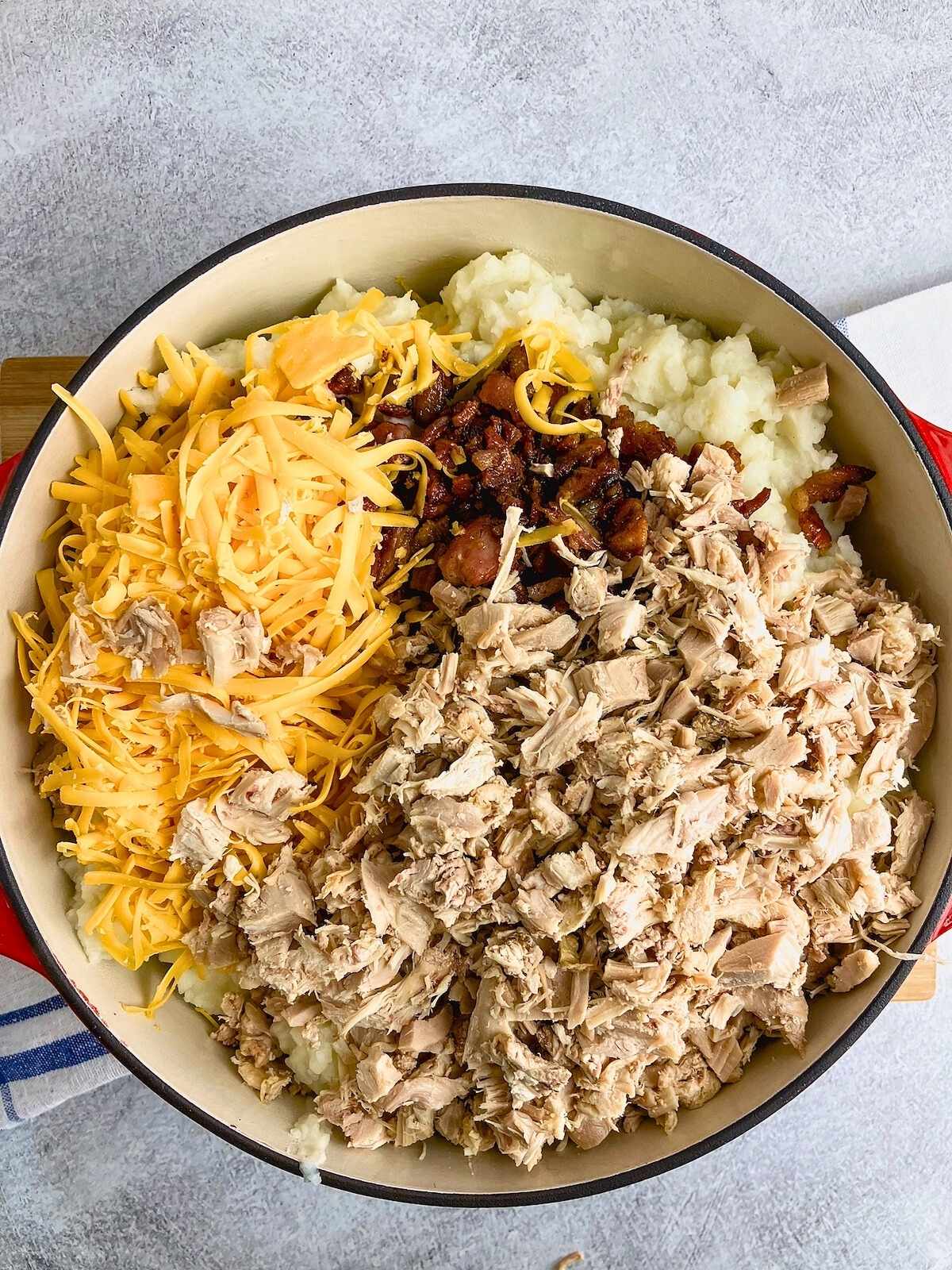 Cooked turkey, bacon, and shredded cheddar cheese were added to the potatoes.