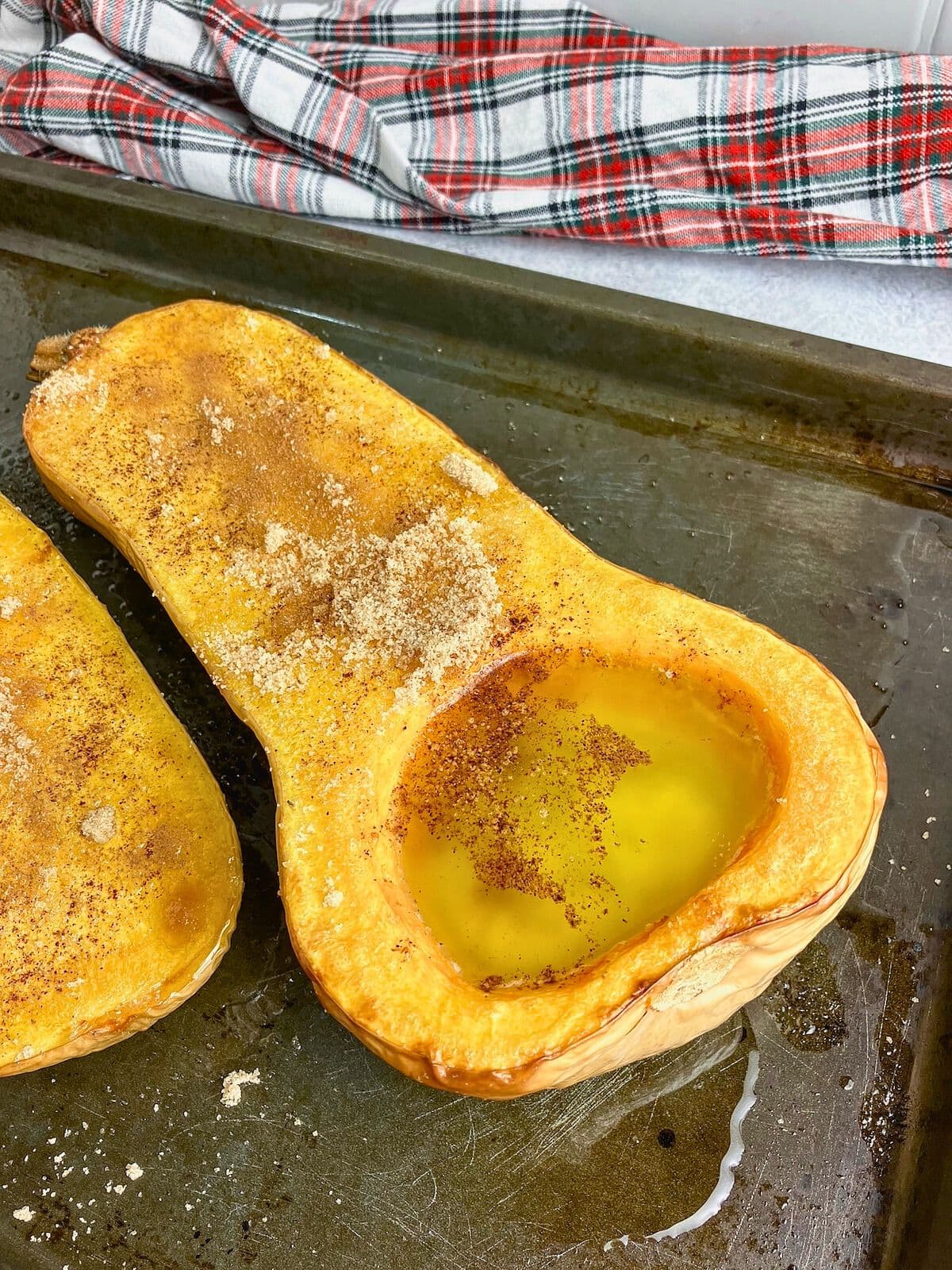 Brown sugar, cinnamon, and maple syrup has been drizzled over top of the squash.