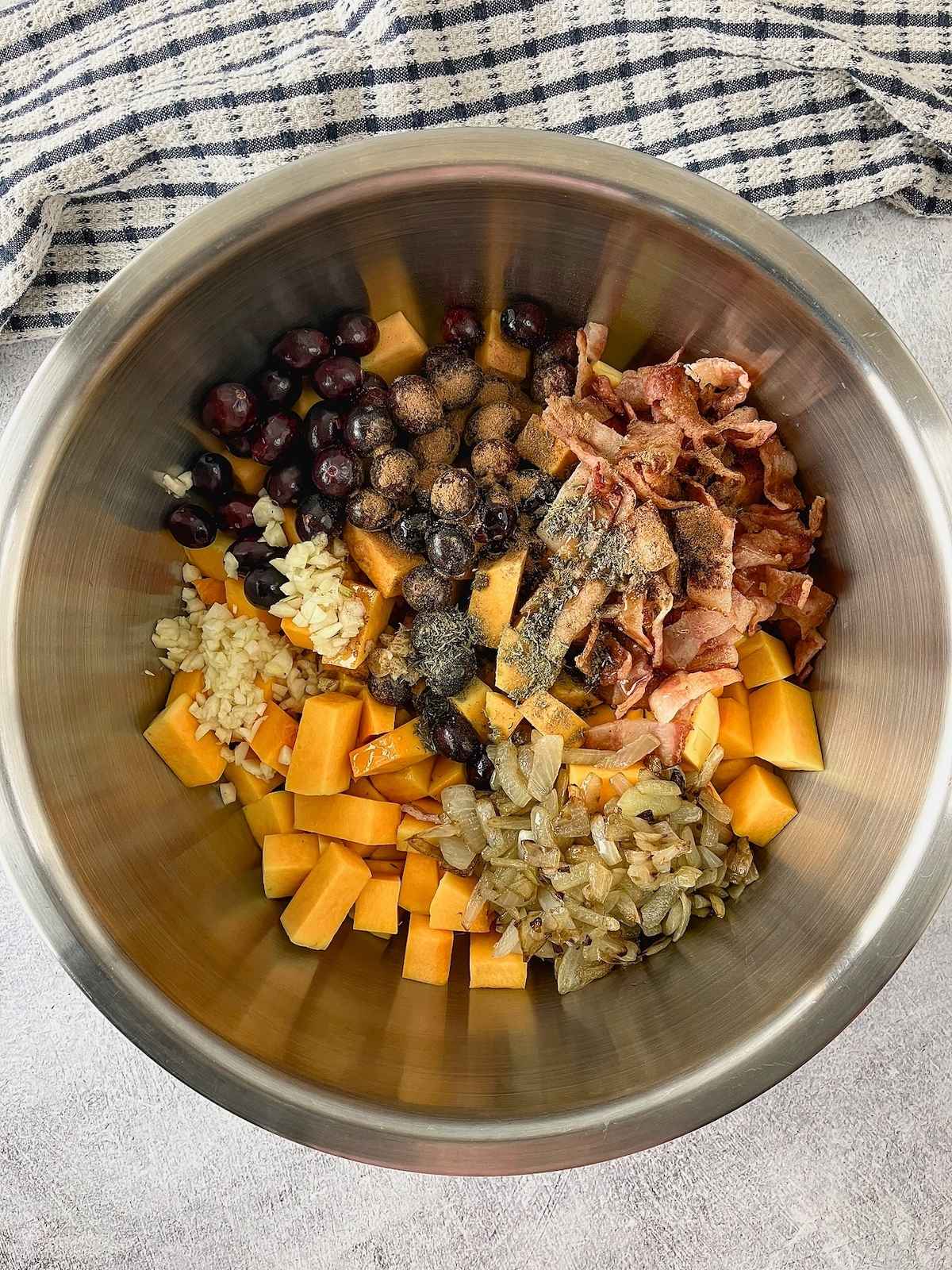 Cooked bacon, caramelized onions, cranberries, garlic, and seasonings were added to the butternut squash.