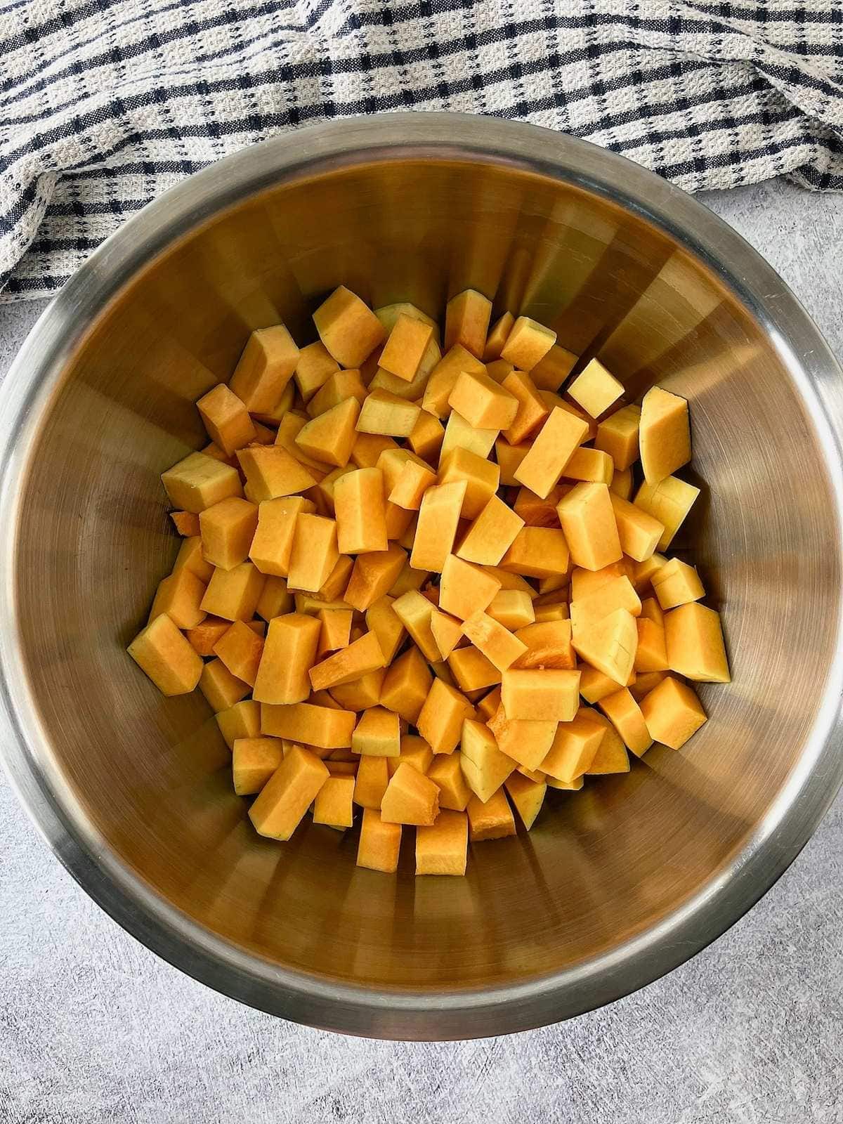 Cubed butternut squash in a large mixing bowl.