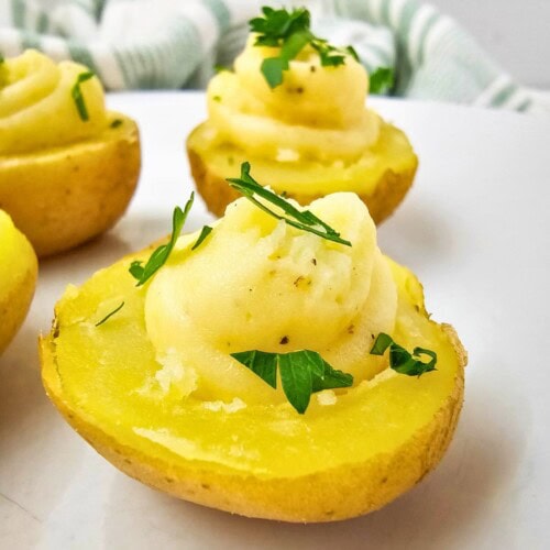 Easy deviled potatoes on a serving tray and topped with fresh parsley.
