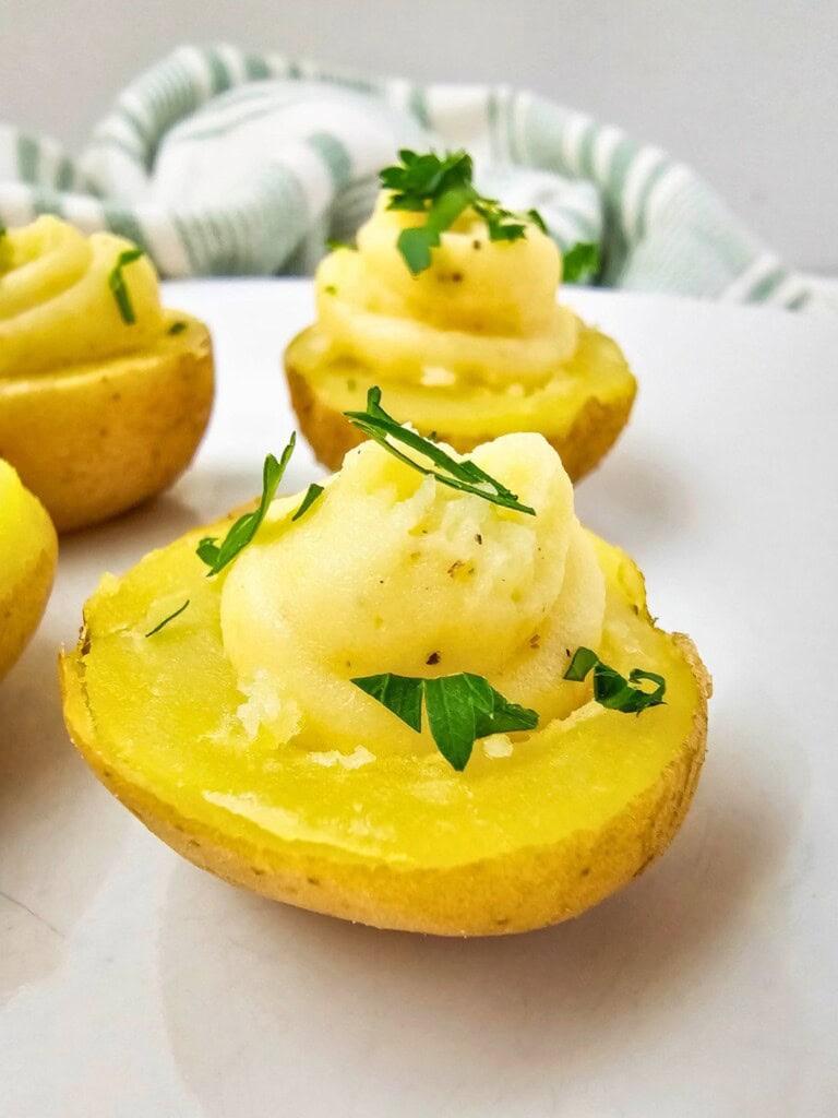 Easy deviled potatoes on a serving tray and topped with fresh parsley.