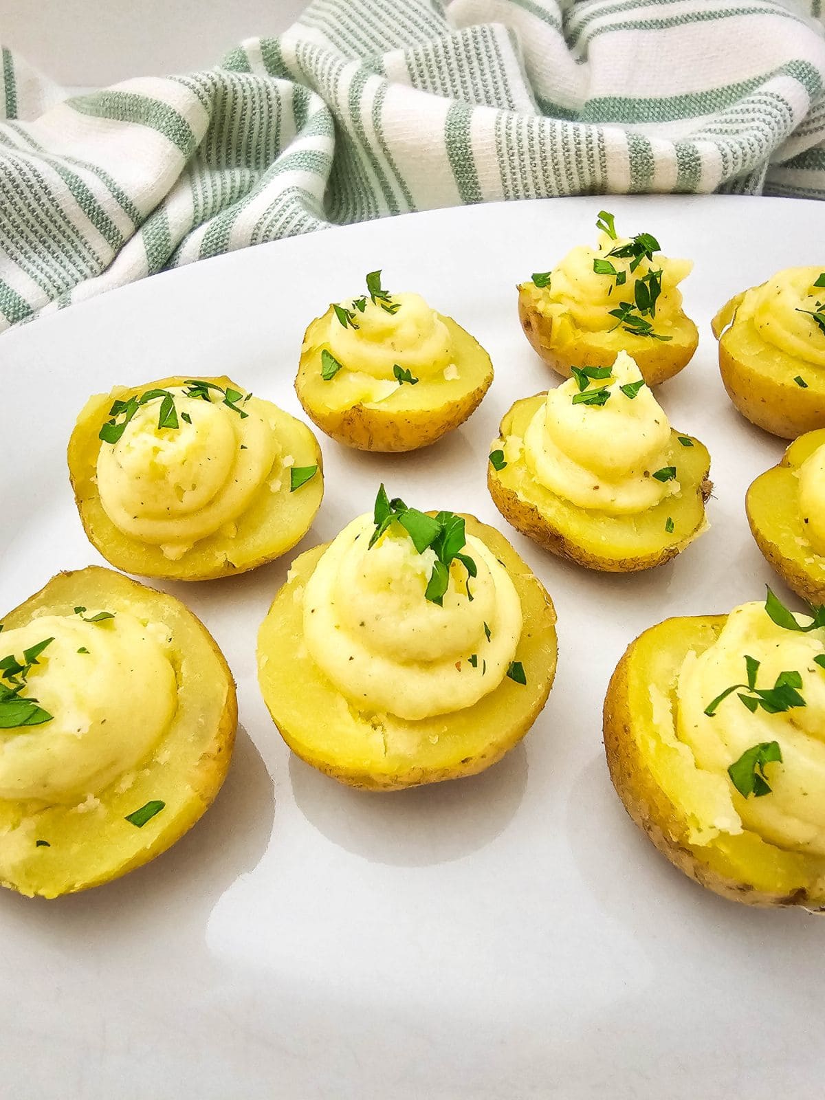 A white serving tray of deviled potatoes.