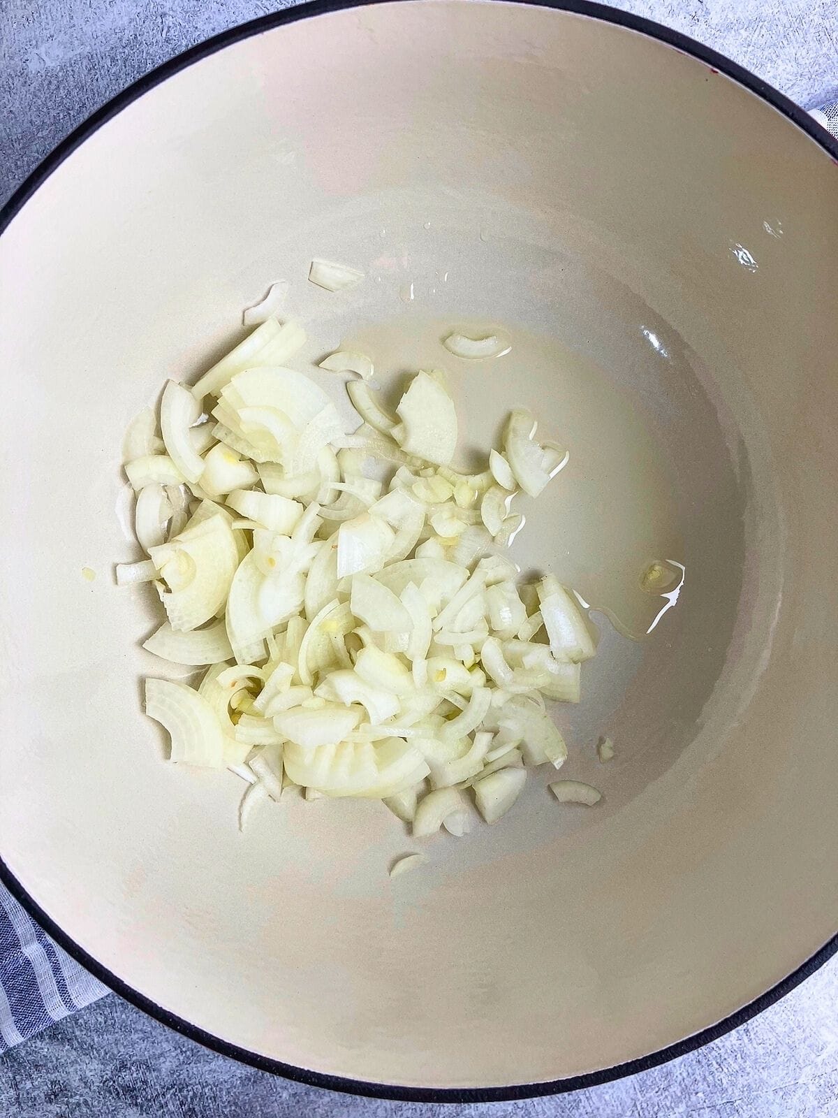 Diced onions were added to the hot oil in the pot.