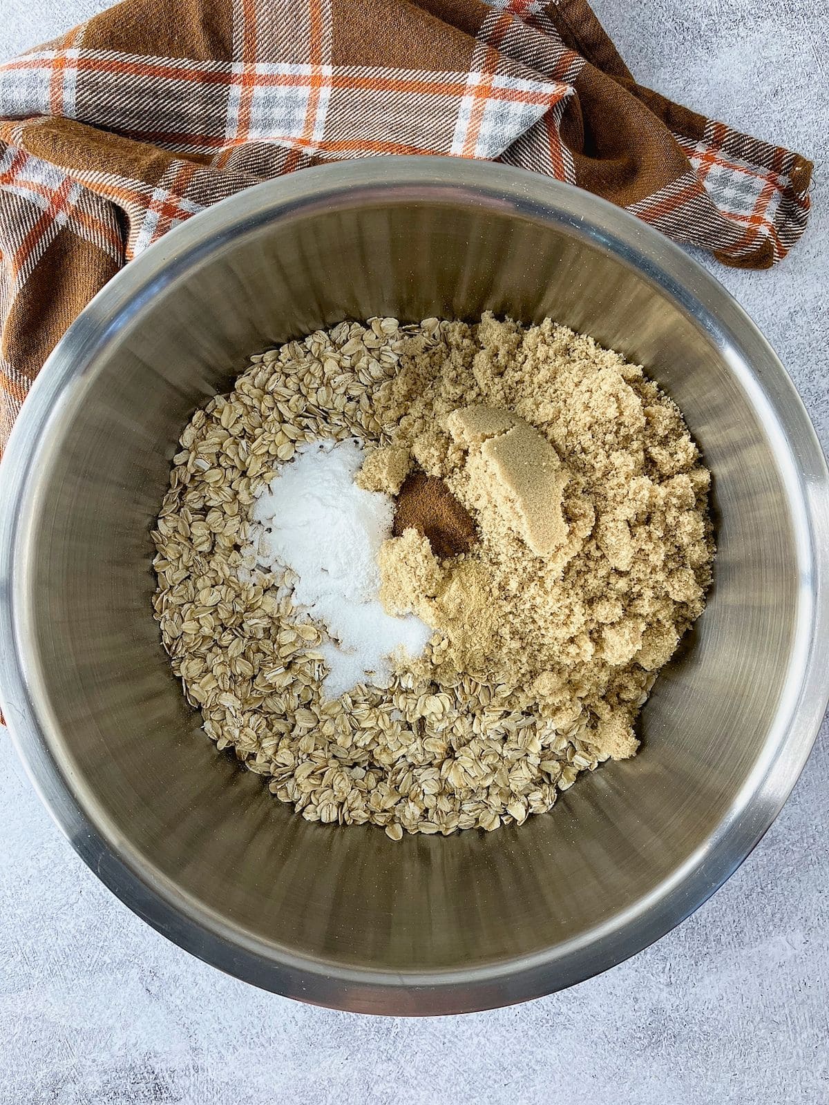The oatmeal, brown sugar, baking powder, and seasonings were added to a large mixing bowl.