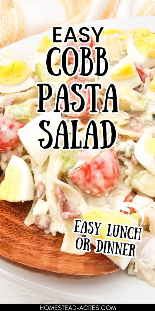 Homemade pasta cobb salad on a serving platter with a wooden spoon. The text overlay says Easy Cobb Pasta Salad Easy Lunch Or Dinner.