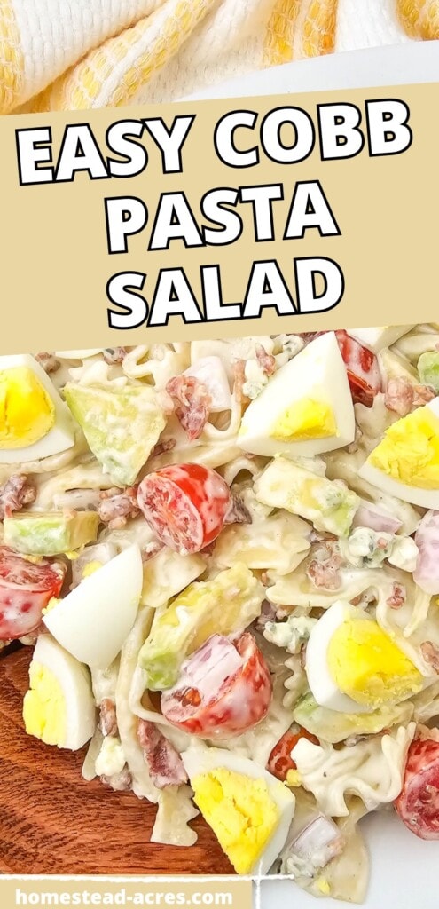 Cobb pasta salad on a white serving platter with a wooden spoon. The text overlay says Easy Cobb Pasta Salad.