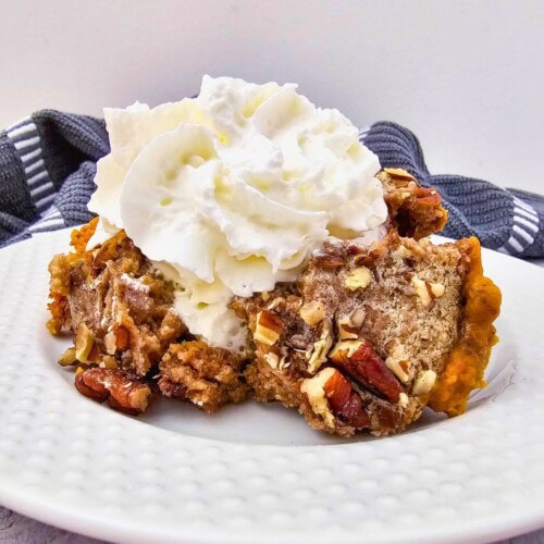 Homemade Crockpot pumpkin dump cake on a white plate.