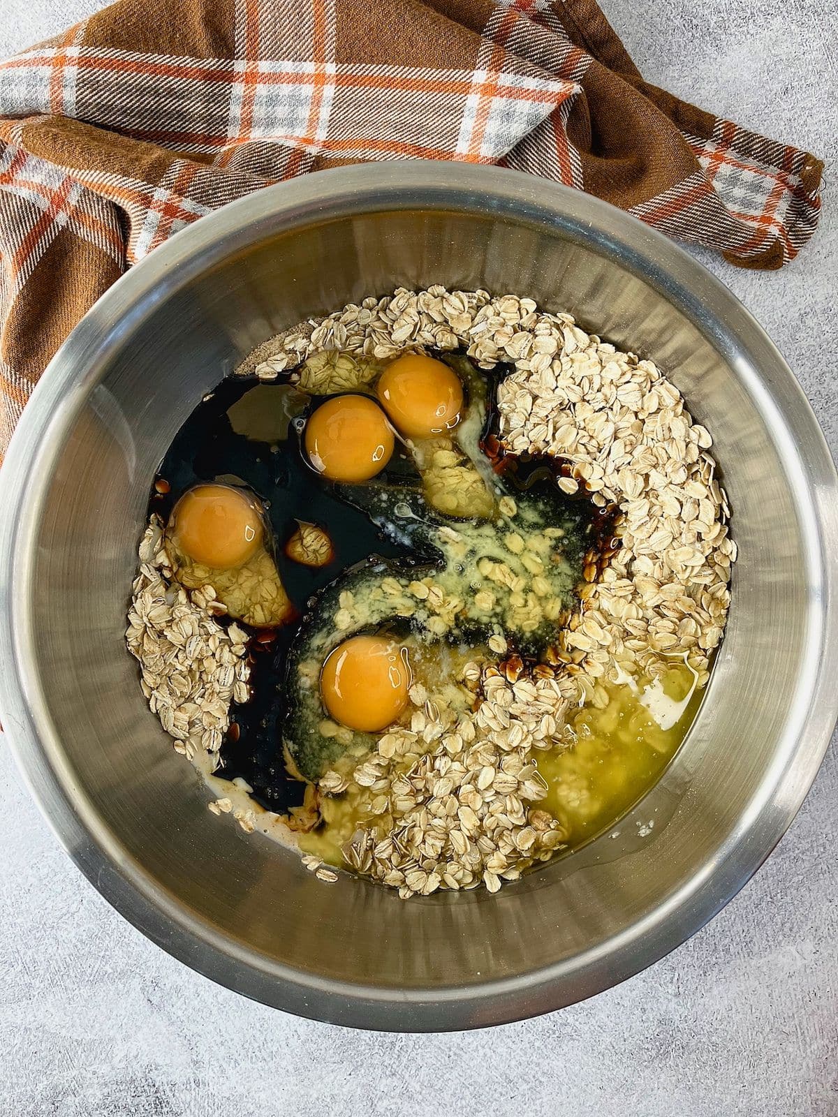 The eggs, butter, molasses, and vanilla were added to the bowl.