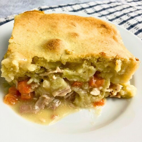 A slice of leftover turkey cornbread casserole on a plate.