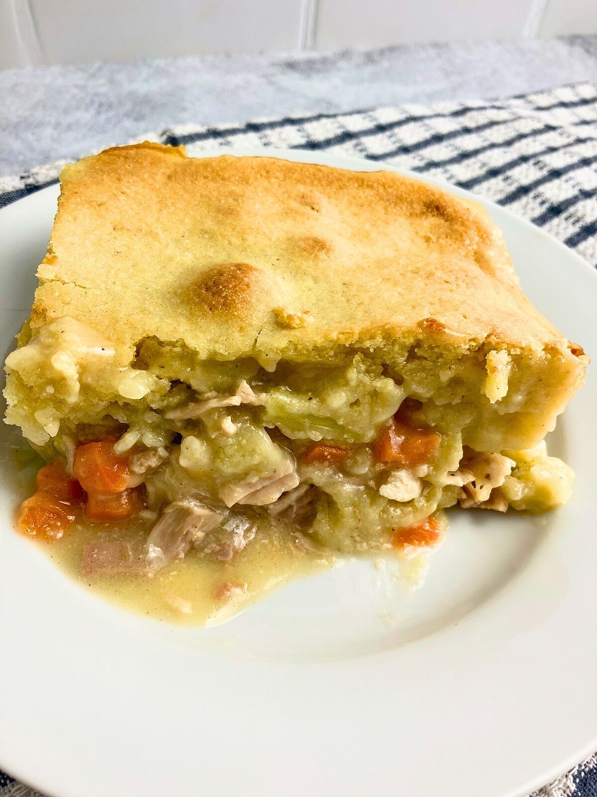 A slice of leftover turkey cornbread casserole on a plate.