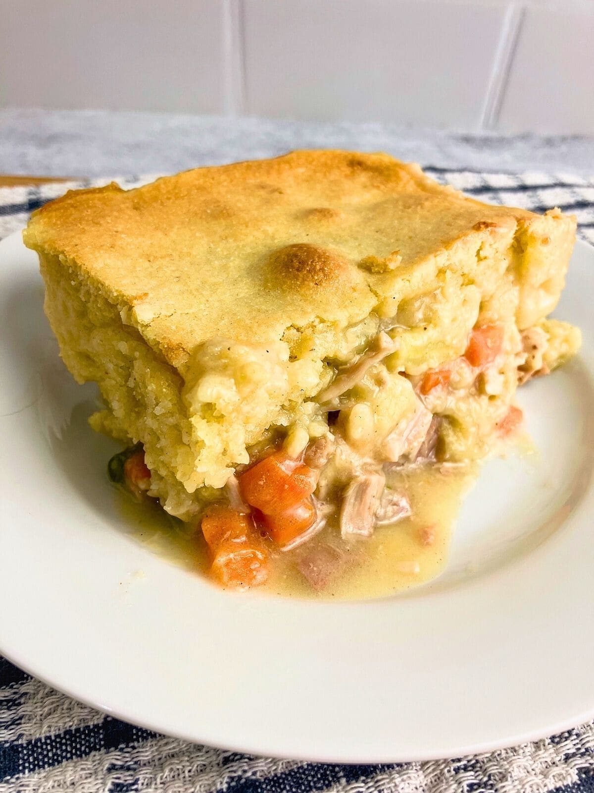 A slice of turkey cornbread casserole on a plate.