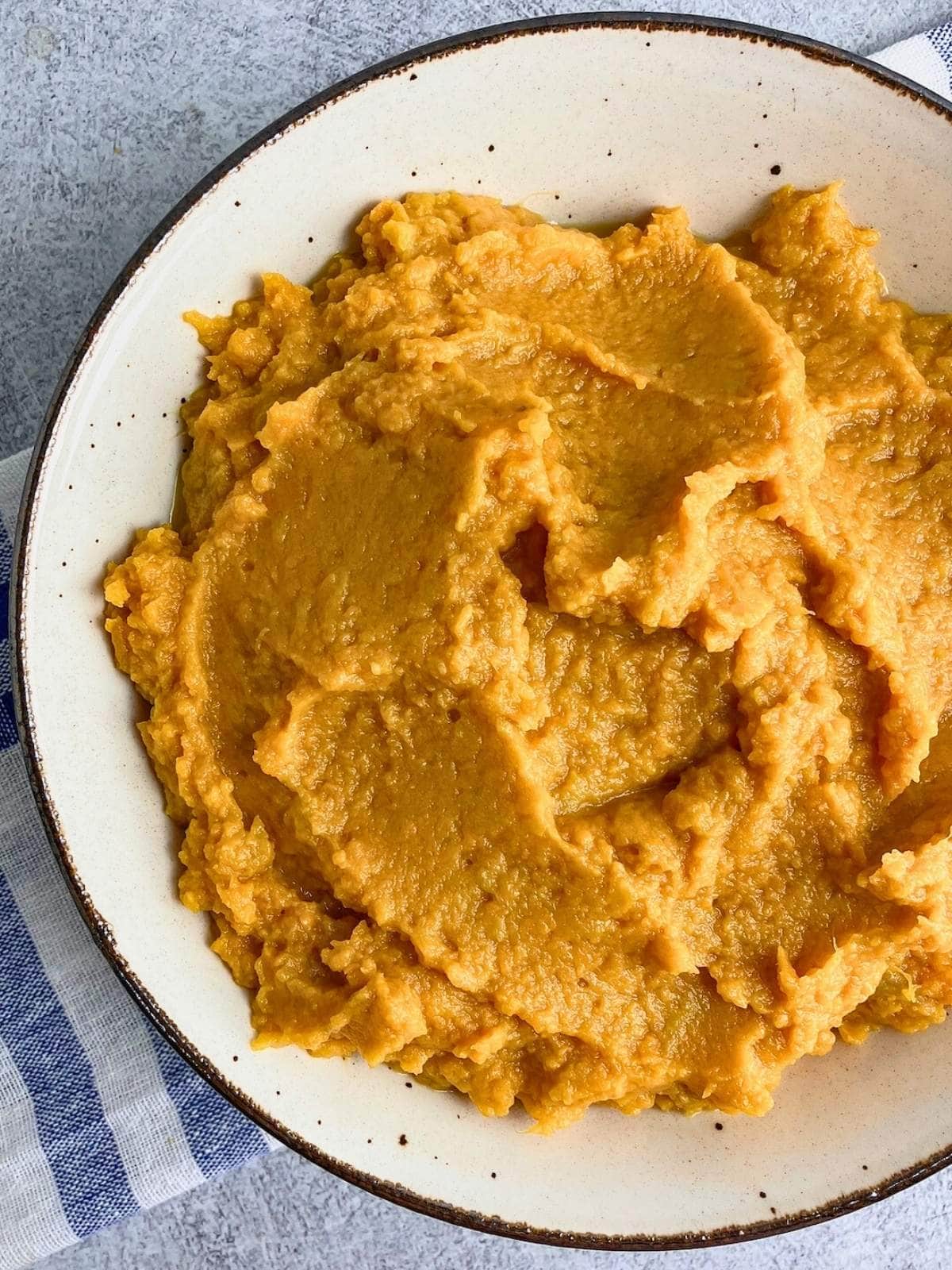 A serving bowl of homemade maple mashed sweet potatoes.