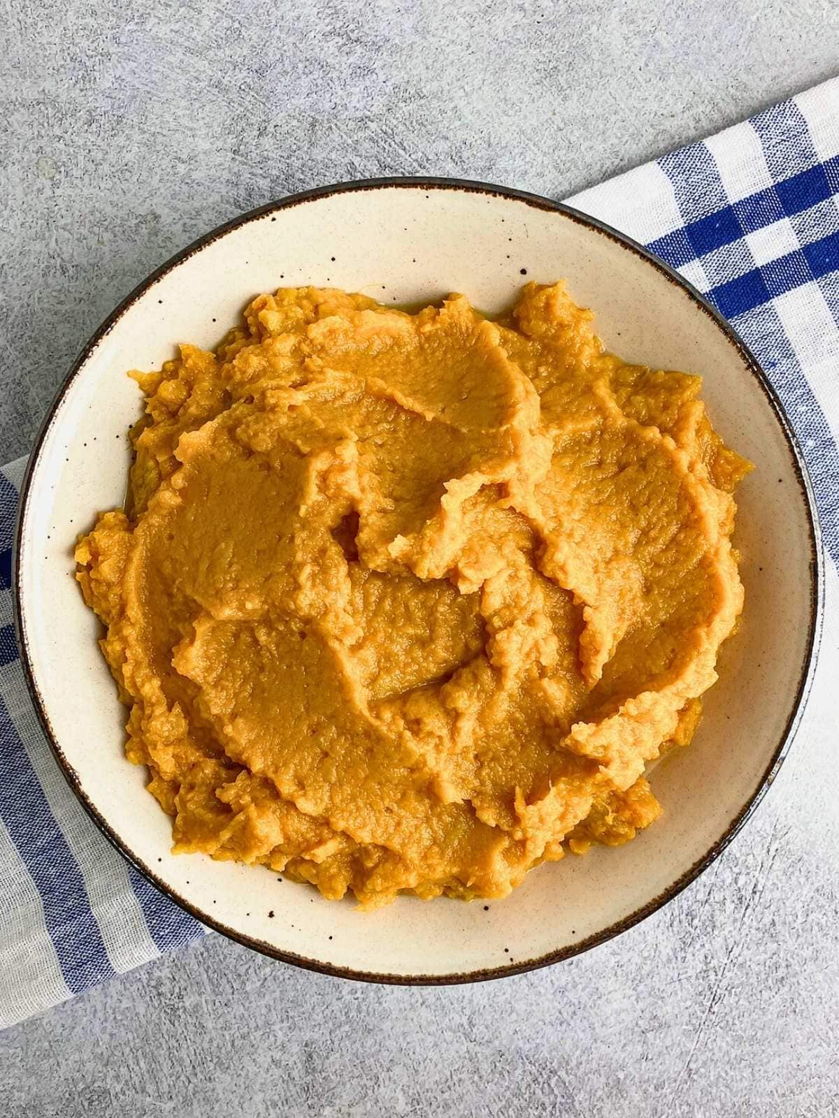 A serving bowl of homemade maple mashed sweet potatoes.