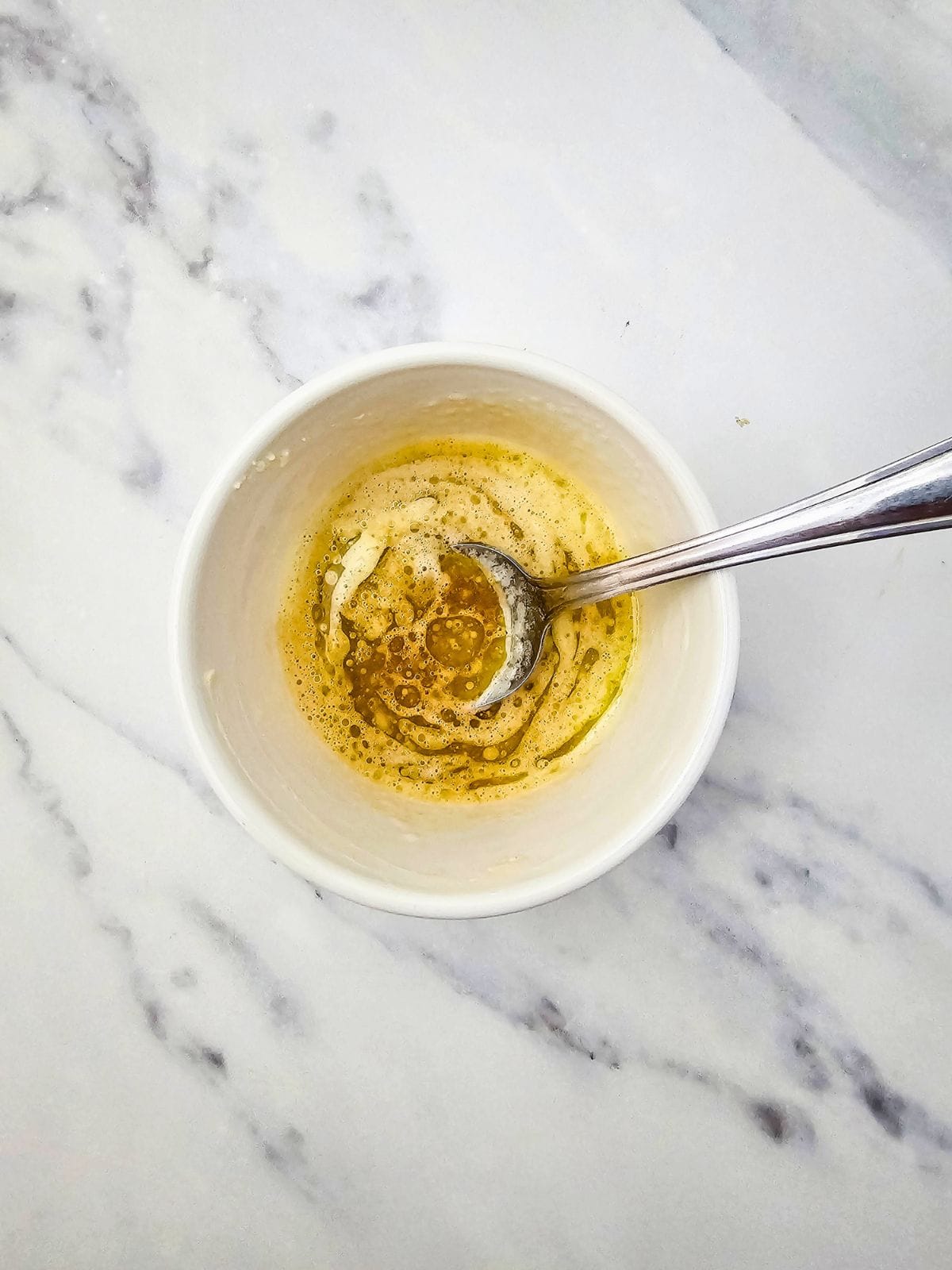 Melted butter and Worcestershire sauce mixed together in a small bowl.