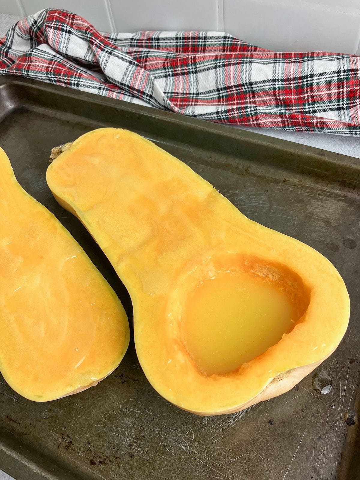 Melted butter has been poured over the squash halves.