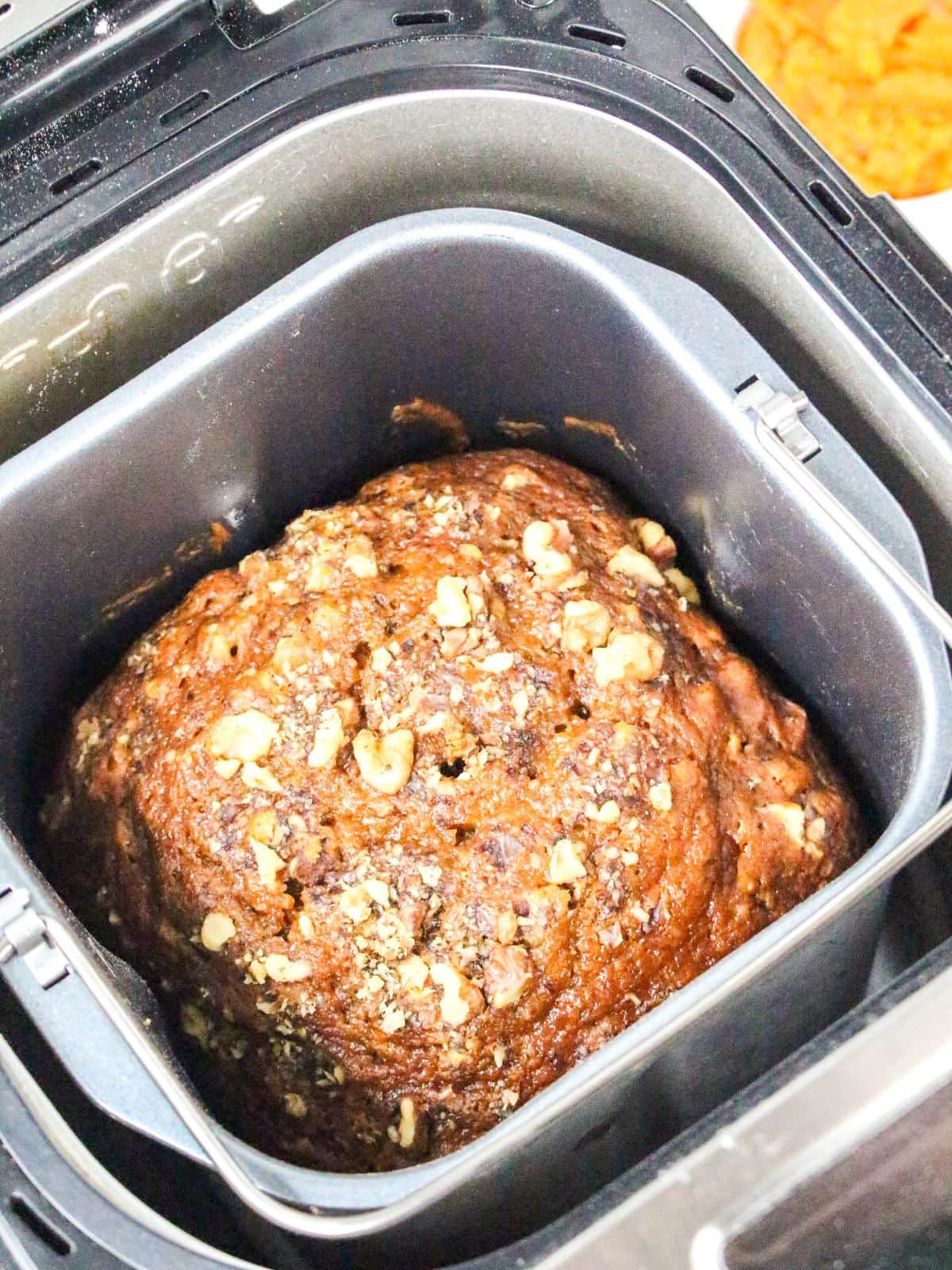 A loaf of baked pumpkin bread in the bread maker.