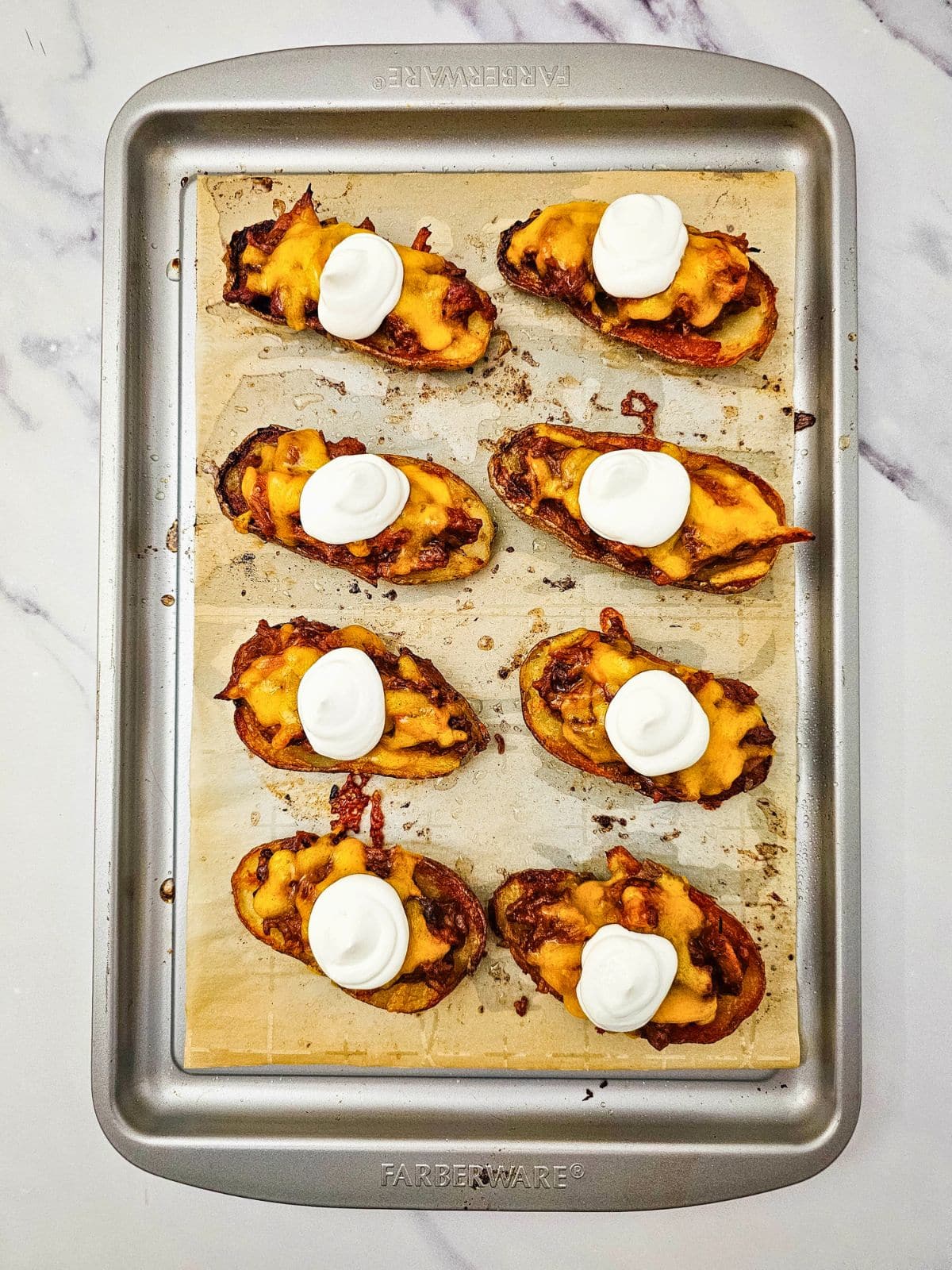 A spoonful of sour cream was added on top of the cooked potato skins.